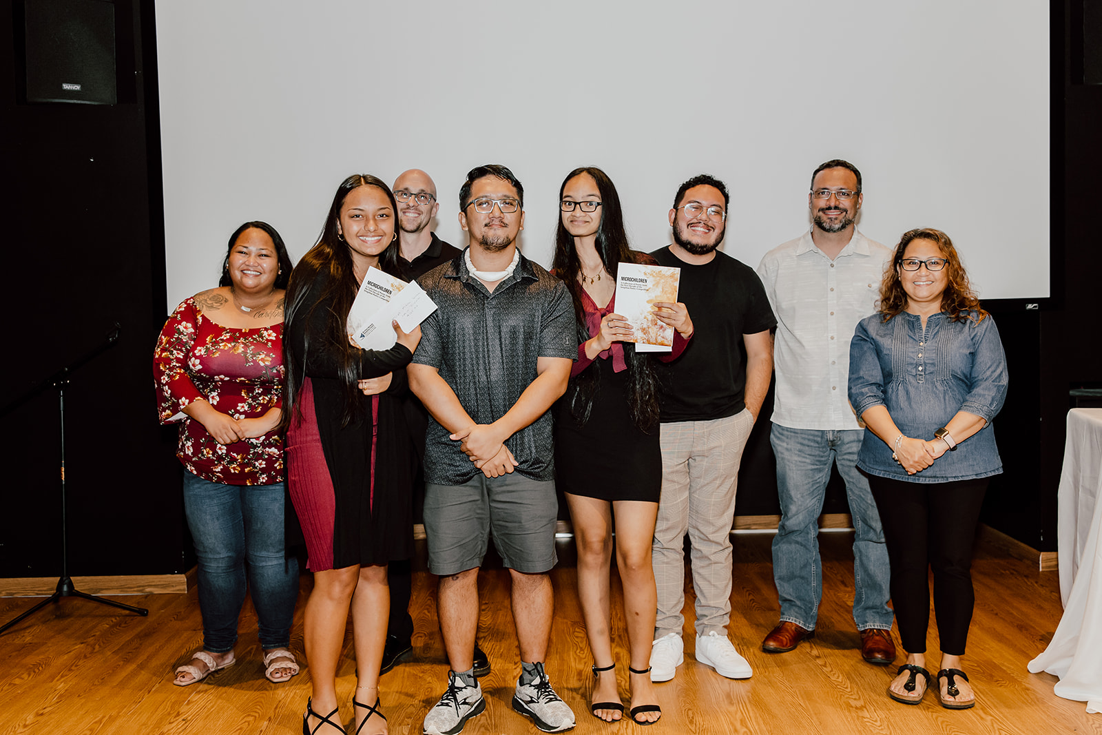 The winners of the 2022 Sengebau Poetry Competition: Kagman High School students D'anahlei Rodriguez and Juneya Quitano pose for  a photo with their teacher Loremel Hocog and judges.