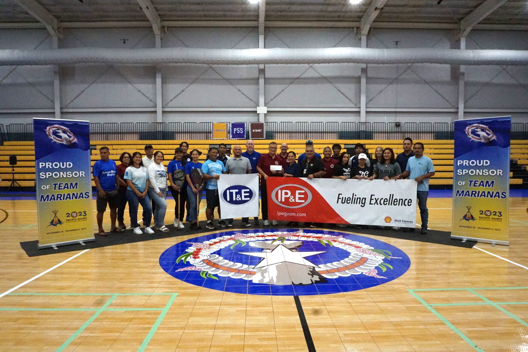 IT&E and IP&E officials and Northern Marianas Sports Association President Jerry Tan pose for a photo with the NMI athletes that will compete in the 2023 Pacific Games from Nov. 19 to Dec. 2 in Honiara, the Solomon Islands.