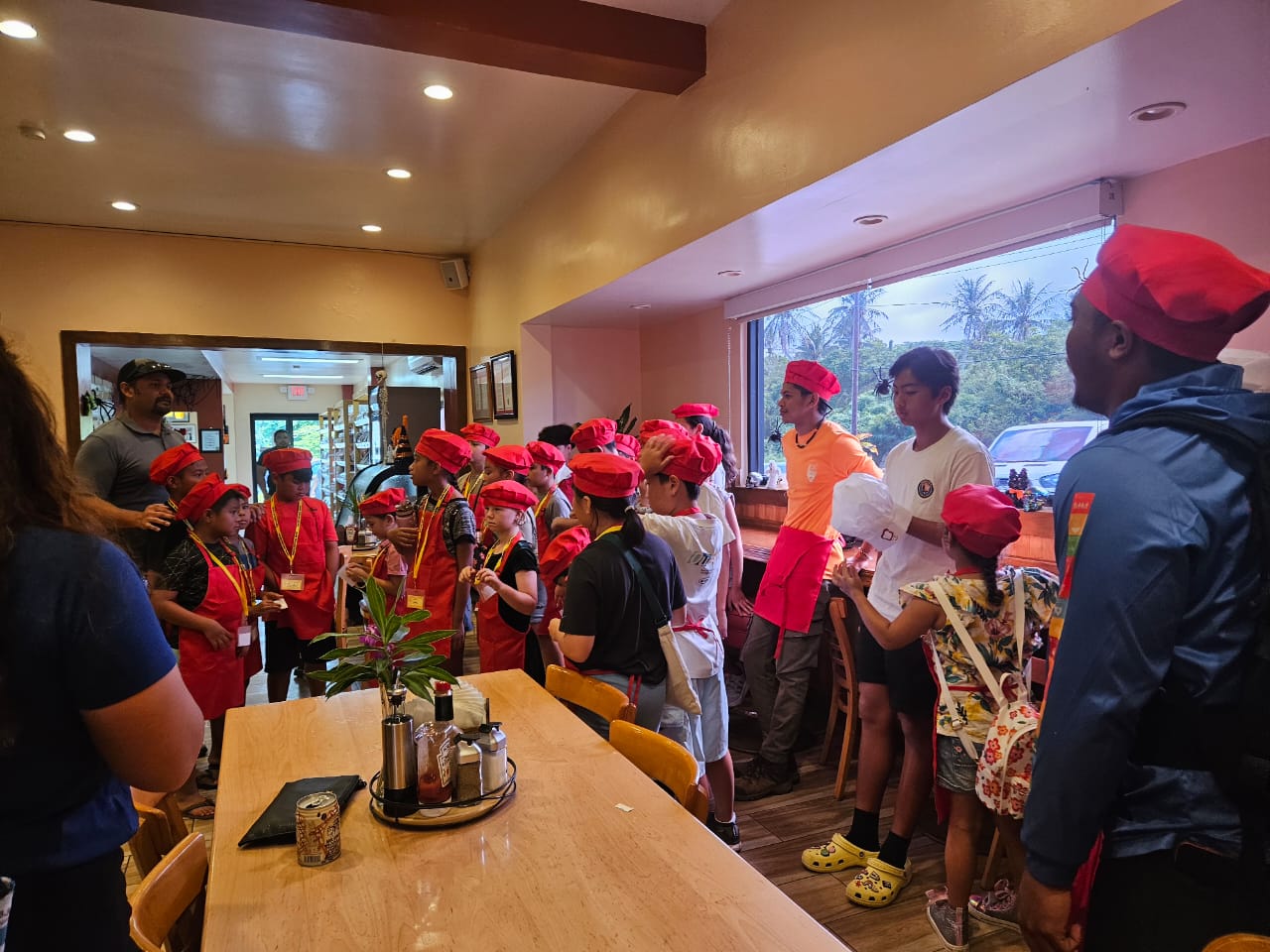 Michael Guerrero with little chefs from AMP during a student tour in Herman's Modern Bakery.
