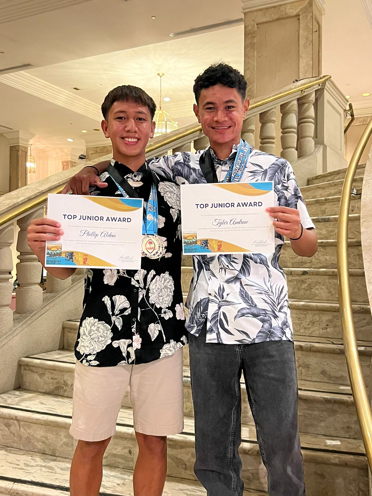 NMI paddlers Philip Aldan and Tyler Andrew hold their awards.