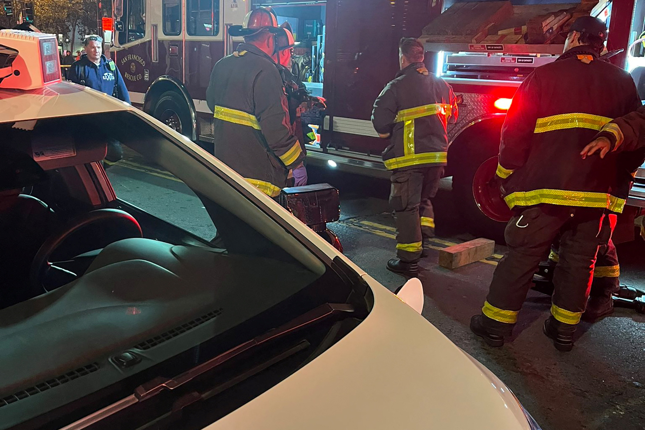 San Francisco firefighters attend the scene where Cruise, General Motors' robotaxi unit, said one of their autonomous vehicles struck and injured a pedestrian who had first been struck by another human-driven vehicle which fled the scene, in San Francisco, California, U.S. October 2, 2023. 