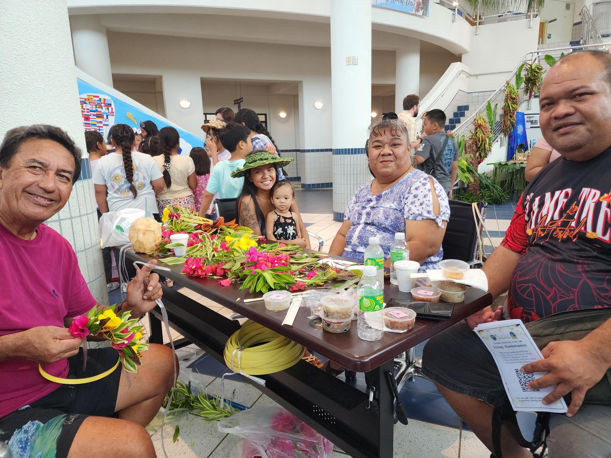 Flower mwaar makers pose for a photo.