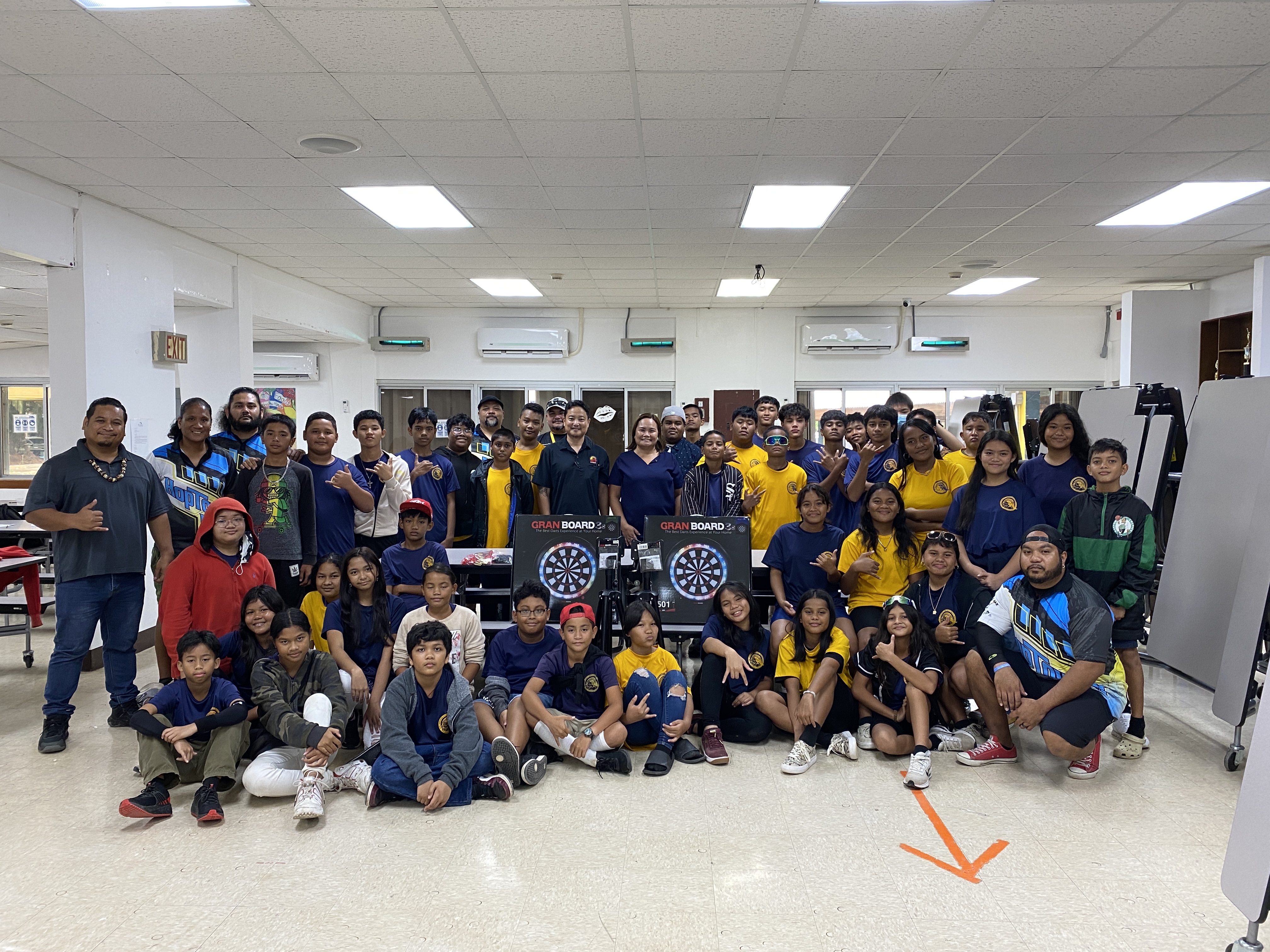 Hopwood Middle School students, staff and principal pose with SEDA and Pacific Amusement Inc. staff who donated dart boards to the school.