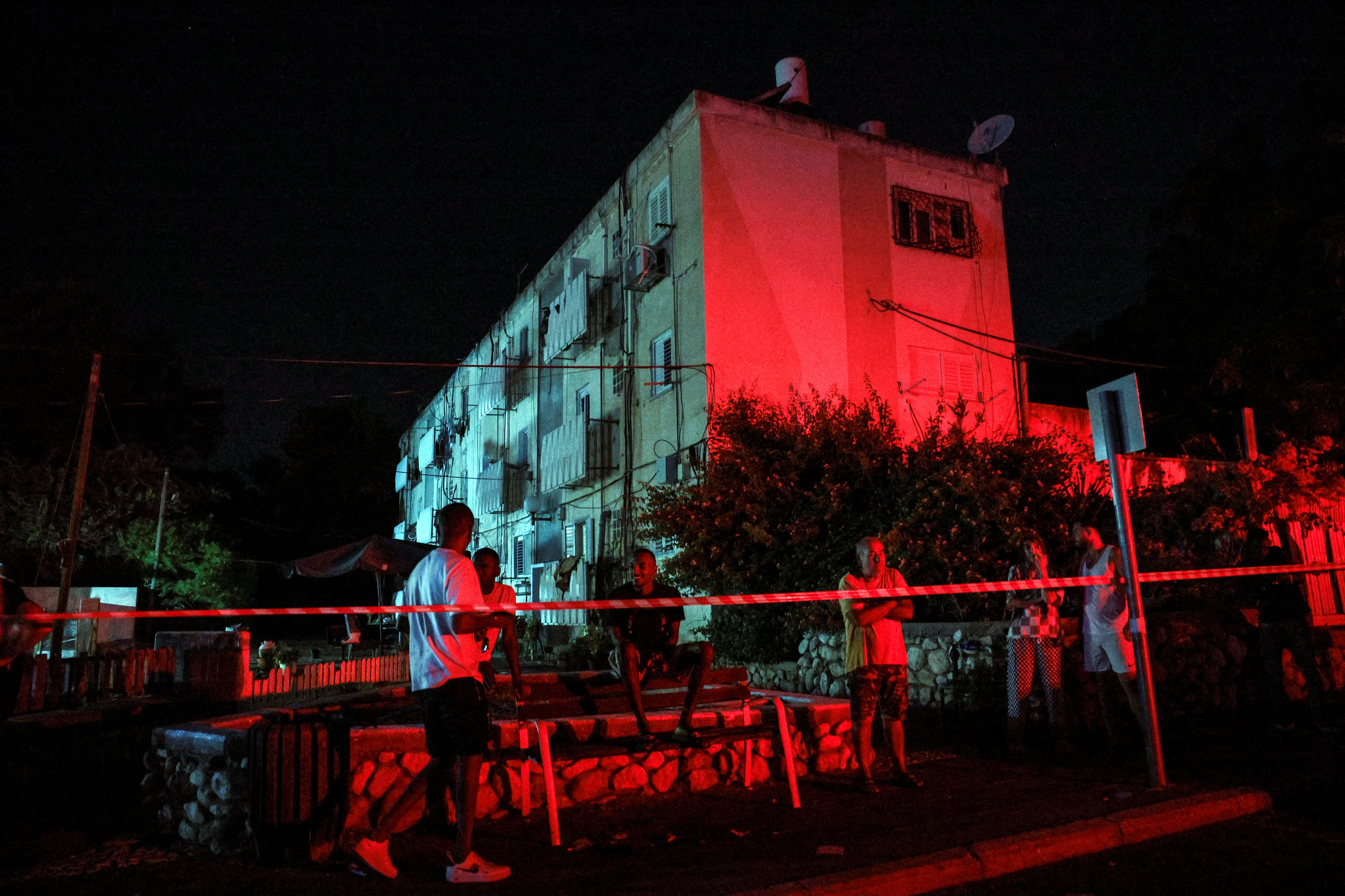 Israelis stand around near a site where a rocket fired from the Gaza Strip landed in Ashkelon, southern Israel October 20, 2023. 