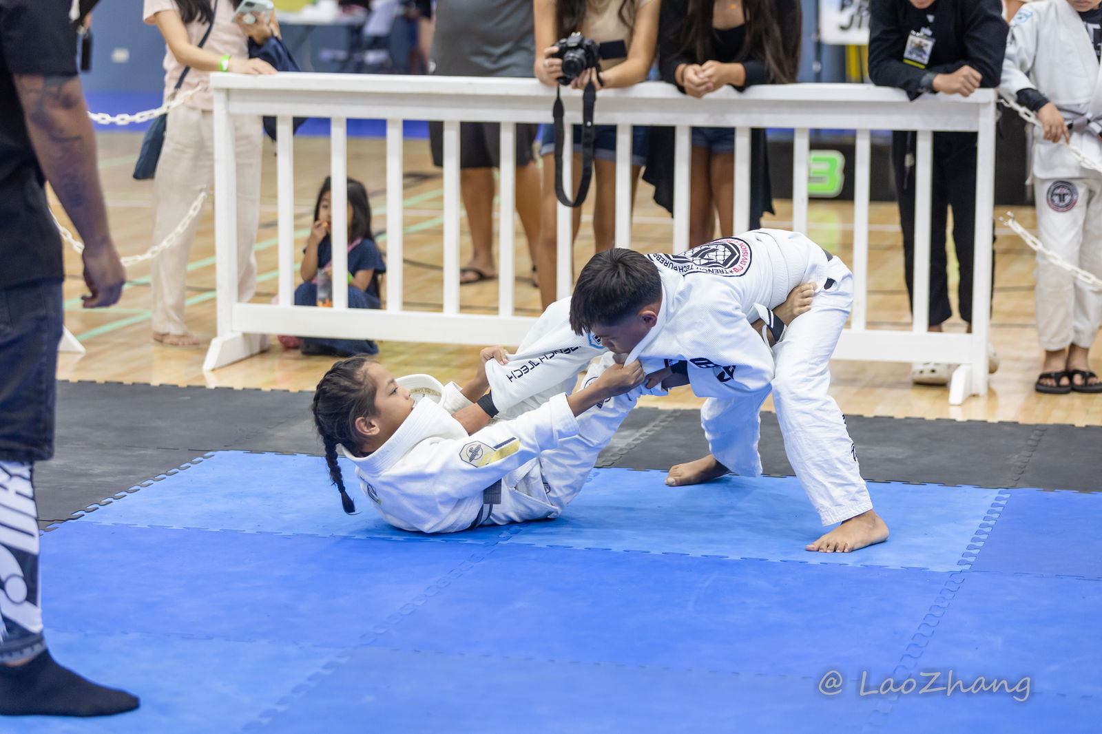 Kaiya Pangelinan pulls guard against Tate Manglona during the Patgon Jiu-Jitsu fundraiser tournament at the Ada gym on Saturday.