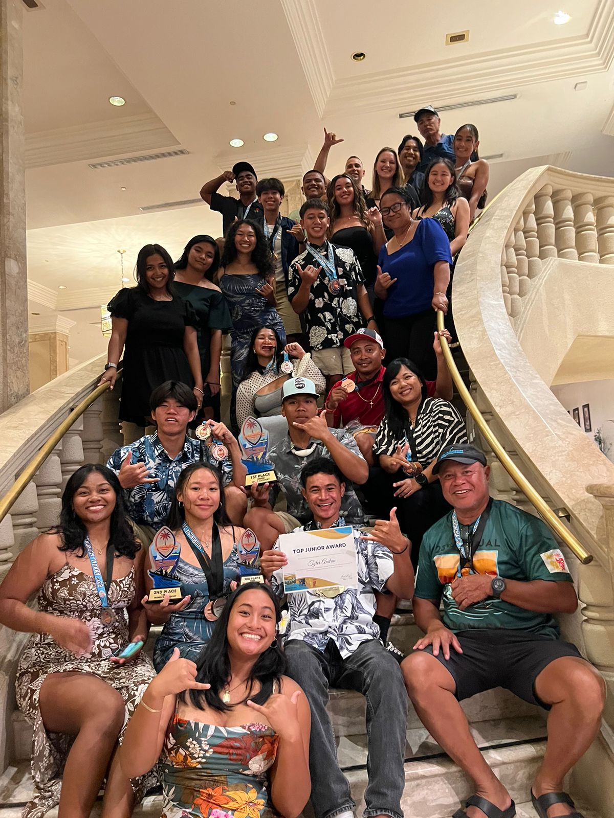 Northern Marianas National Paddle Sports Federation President Justin Andrew, right, and NMI paddlers pose for a photo after the awarding ceremony of the 3rd Annual Micronesia Cup Canoe Race in Guam on Sunday.