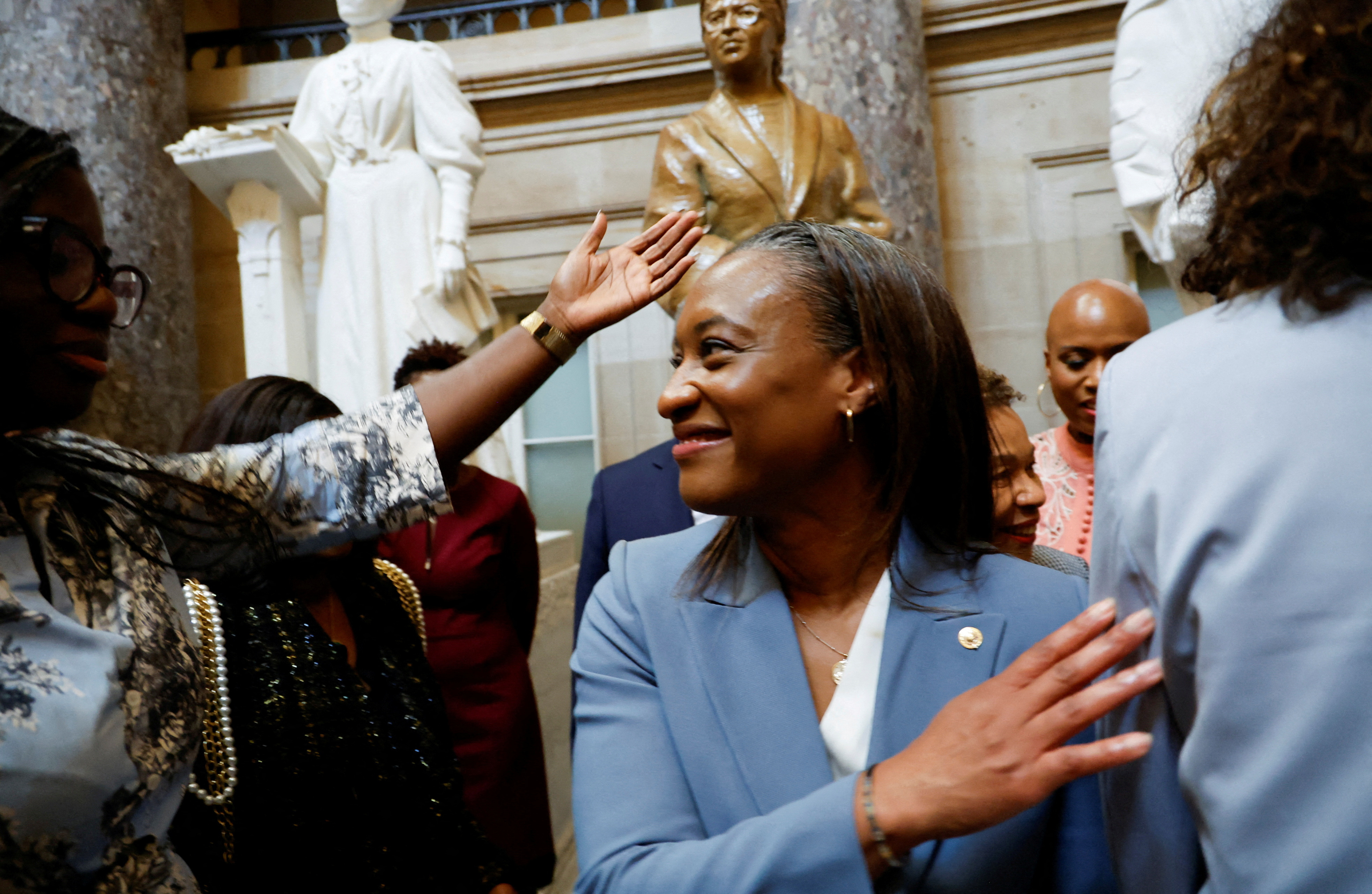 U.S. Senator Laphonza Butler (D-CA) is congratulated by new colleagues from the Congressional Black Caucus after being sworn in as the newest member of the caucus in front of the statue of civil rights leader Rosa Parks in Statuary Hall, shortly after Butler was sworn in to fill the U.S. Senate vacancy caused by the recent death of U.S. Senator Dianne Feinstein (D-CA), at the Capitol in Washington, U.S., October 3, 2023. 