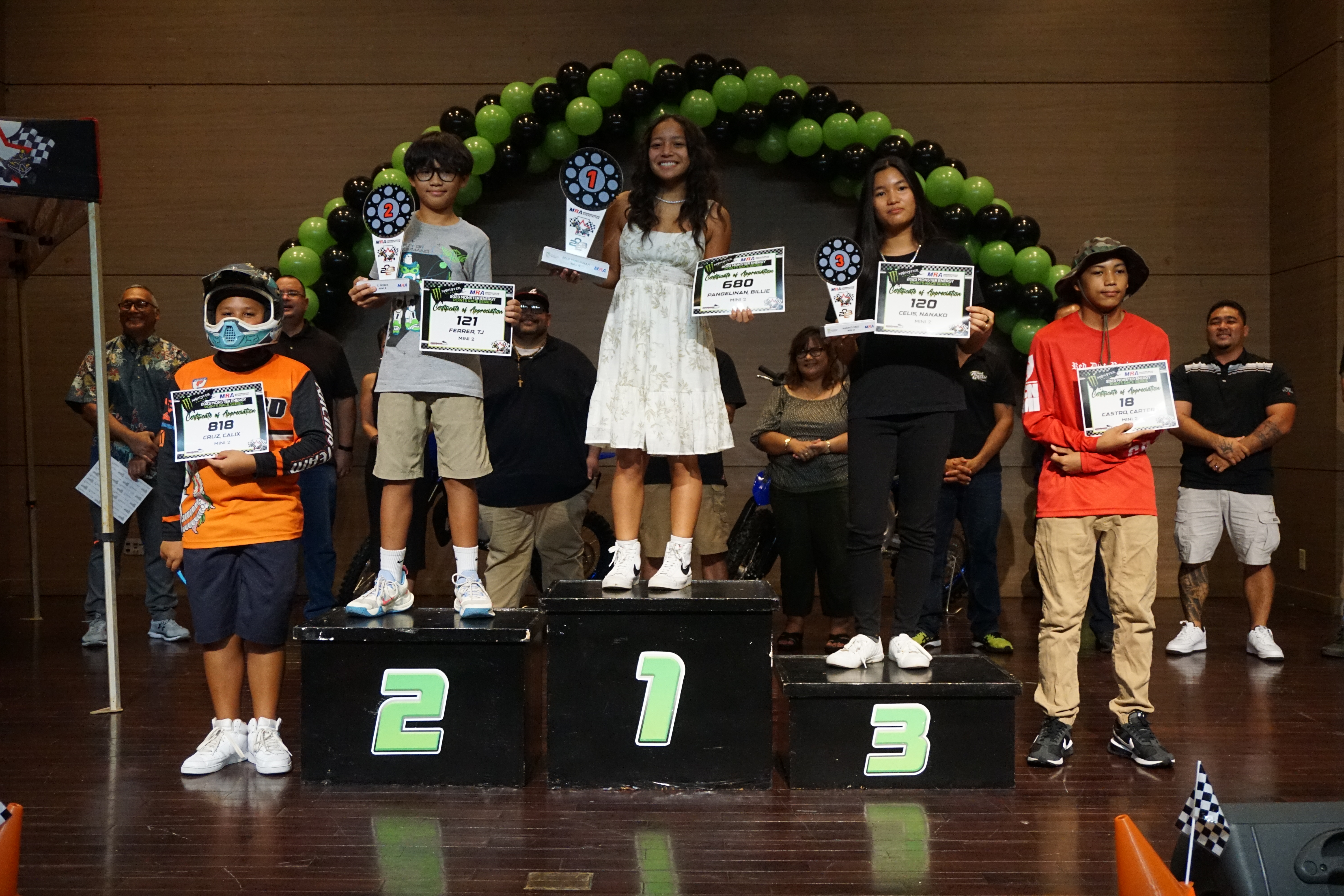 Billie Pangelinan smiles with her first-place trophy as she poses for a photo with the  rest of the Mini 2 Class riders of the 2023 MRA Monster Energy Points Race Series during the awards ceremony on Saturday at the Saipan World Resort Taga Hall.