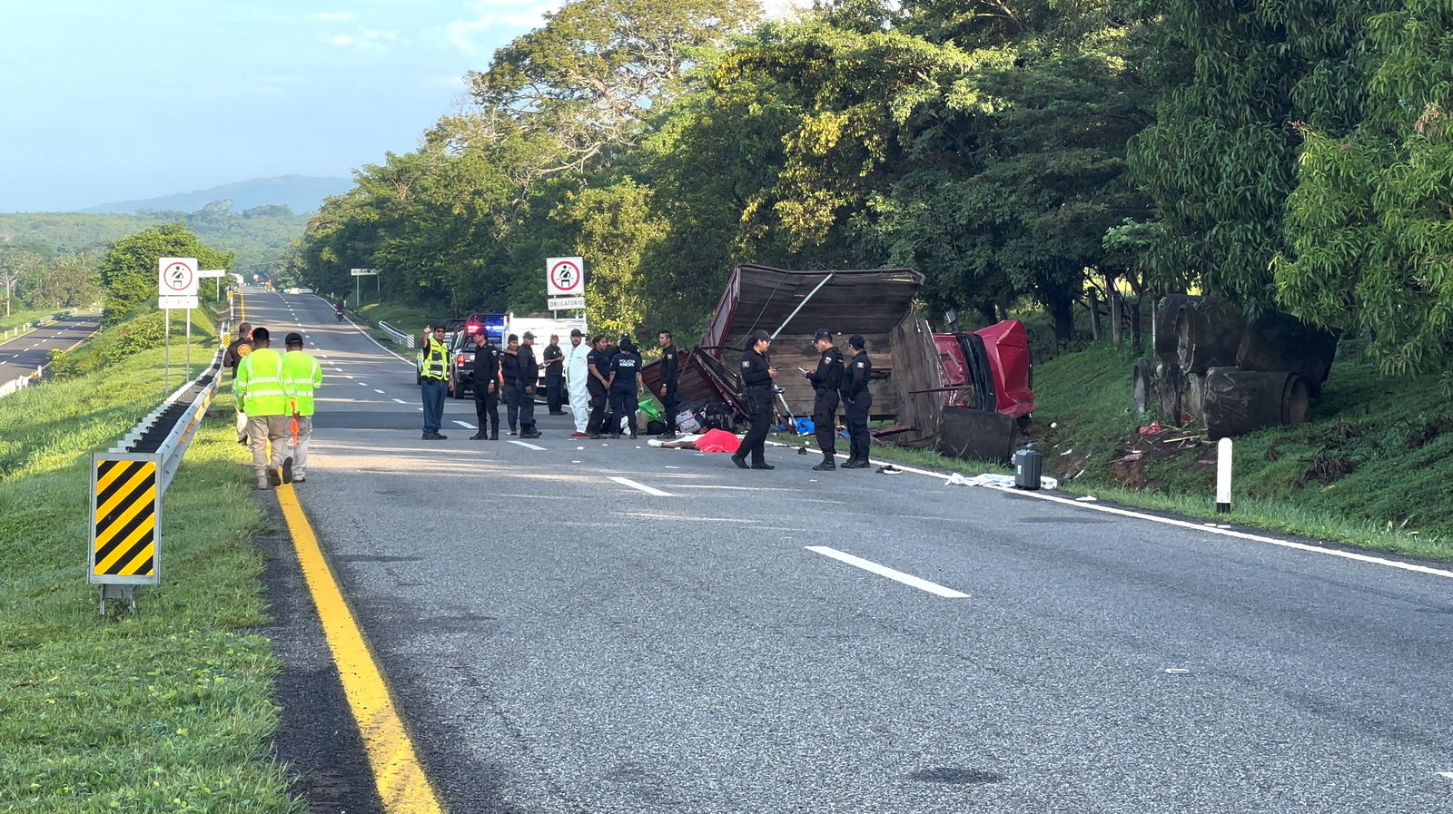 Emergency personnel work at the scene where several Cuban migrants died after a truck accident in Pijijiapan, Chiapas, Mexico October 1, 2023, in this screen grabs taken from a handout video. 
