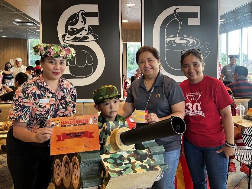 Most Creative Costume winner, Colin Lilles, poses with judges  Jhaymee Nebres, McDonald’s Department Manager; Narme Menoda, McDonald’s IT/Tech Support; and Connie Medino, McDonald’s Payroll Admin.