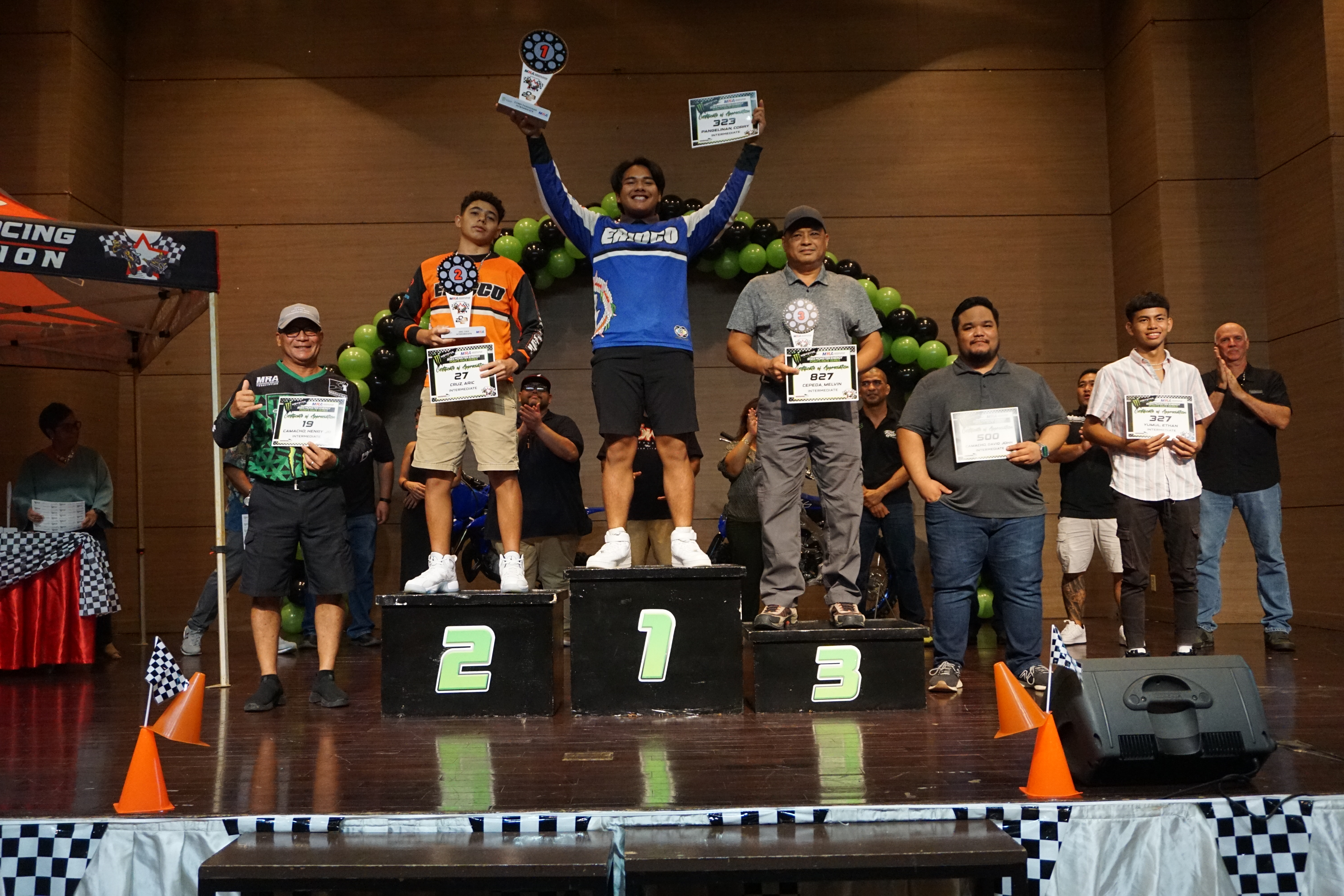 Corry Pangelinan holds the first-place trophy as he poses for a photo with the other Intermediate Class riders of the 2023 MRA Monster Energy Points Race Series during the awards ceremony on Saturday at the Saipan World Resort Taga Hall.