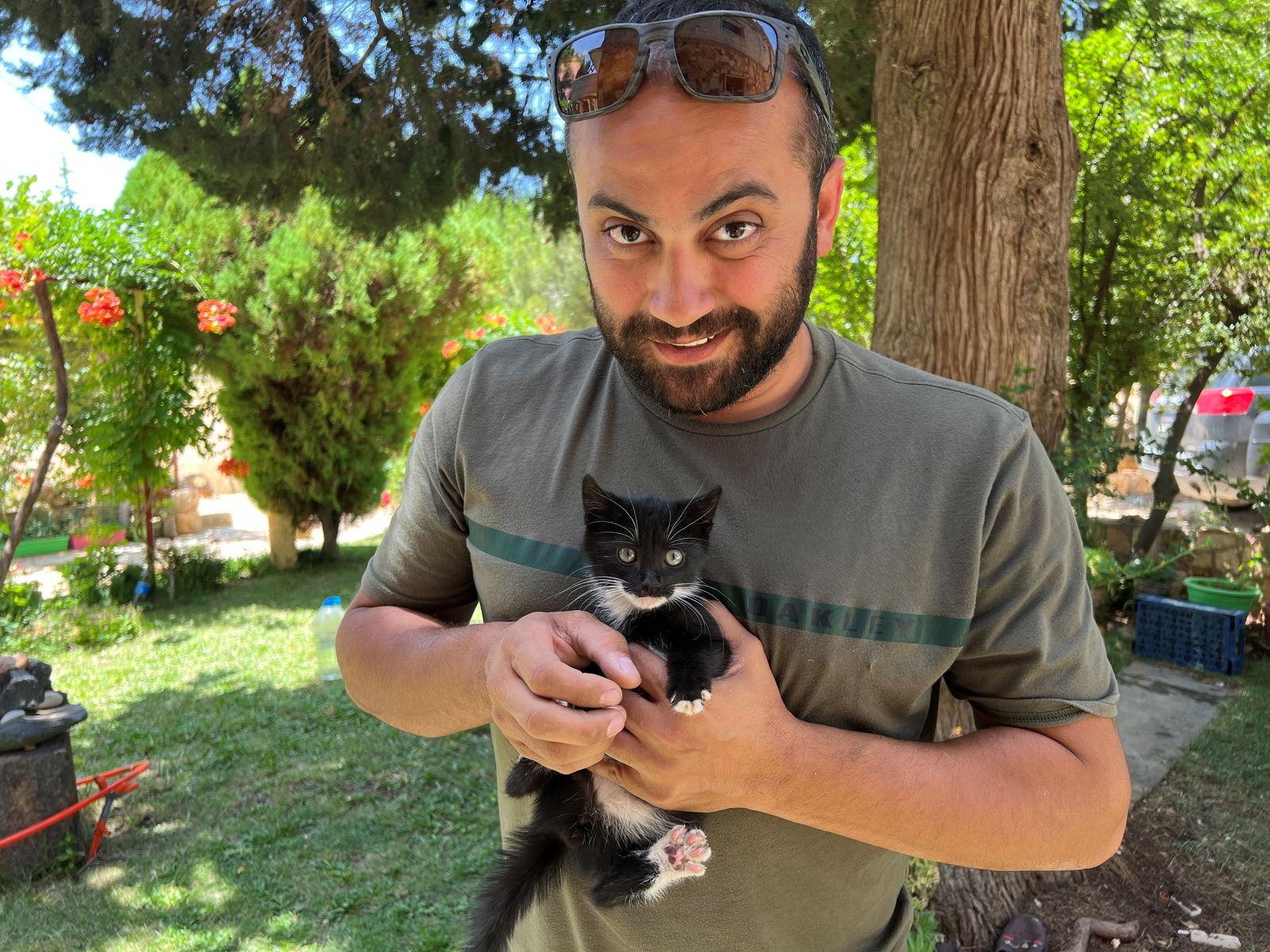 Reuters' journalist Issam Abdallah holds a kitten while posing for a picture in Saaideh, Lebanon, July 4, 2023. REUTERS/Emilie Madi/File Photo