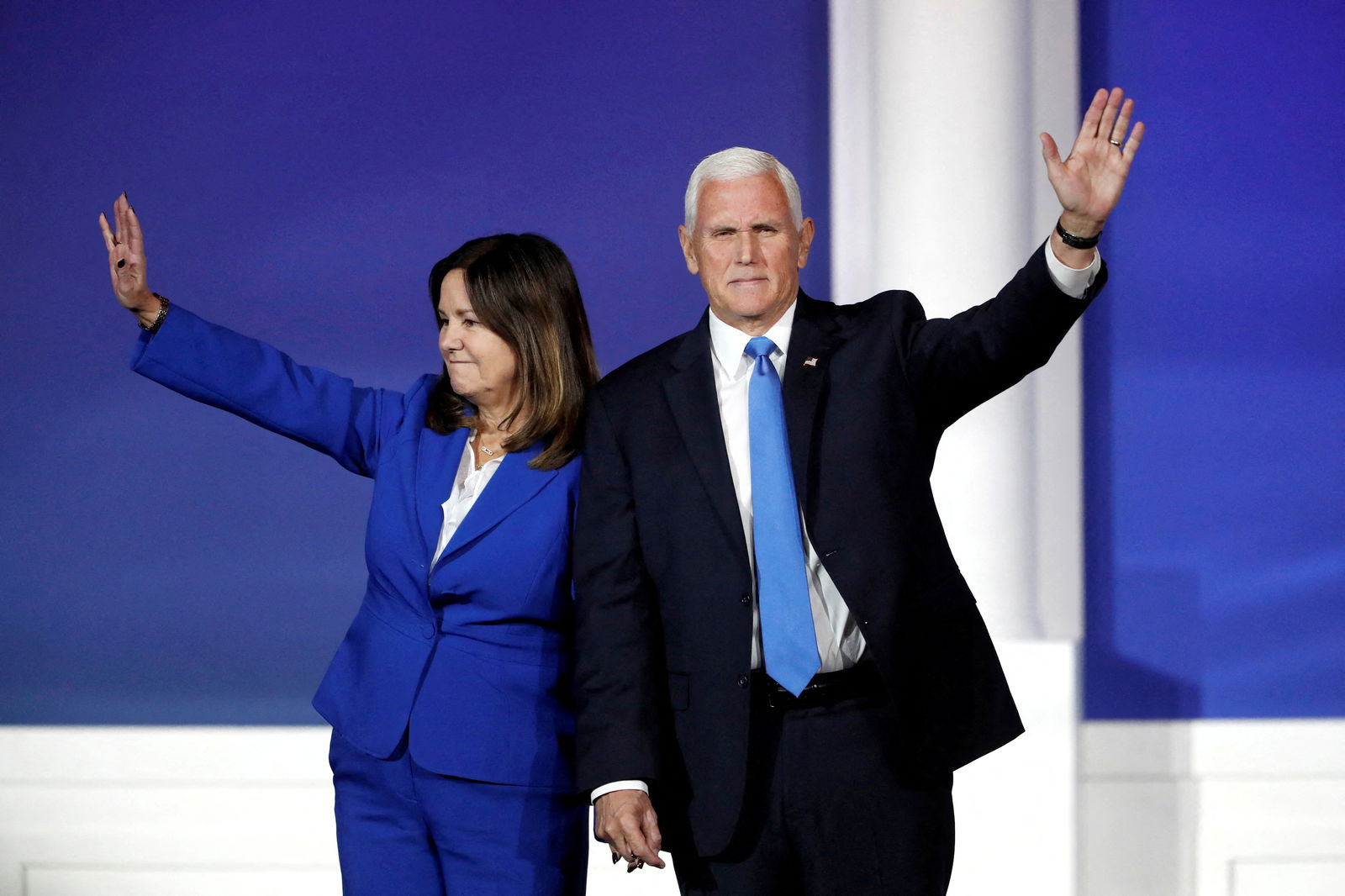 Former U.S. Vice President Mike Pence waves with his wife Karen as he leaves the stage after announcing he is withdrawing from the presidential campaign, during the Republican Jewish Coalition Annual Leadership Summit in Las Vegas, Nevada, U.S. October 28, 2023. 
