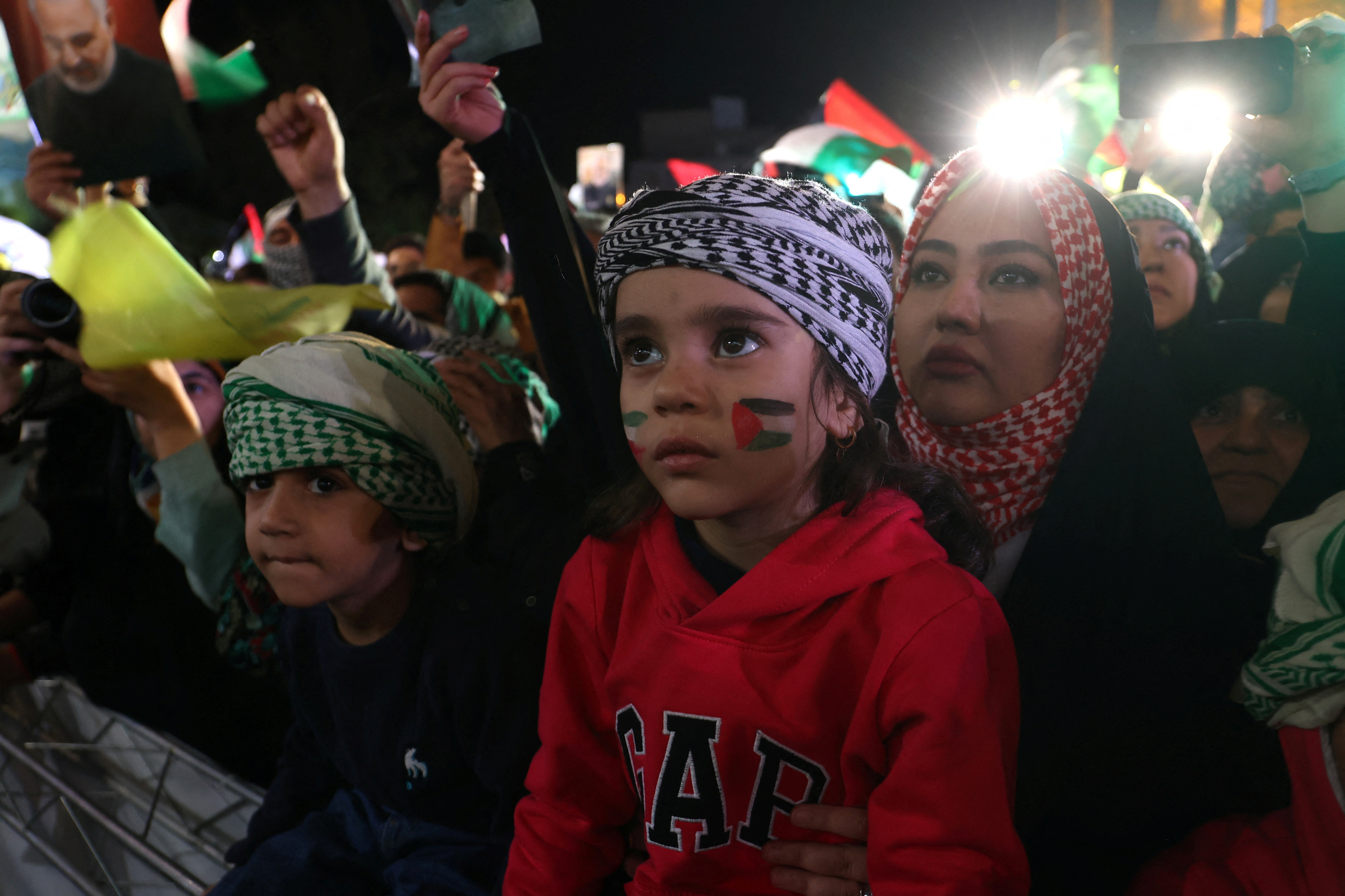 An Iranian child painted a Palestinian flag on her face during an anti-Israel protest in Tehran, Iran, October 20, 2023. 