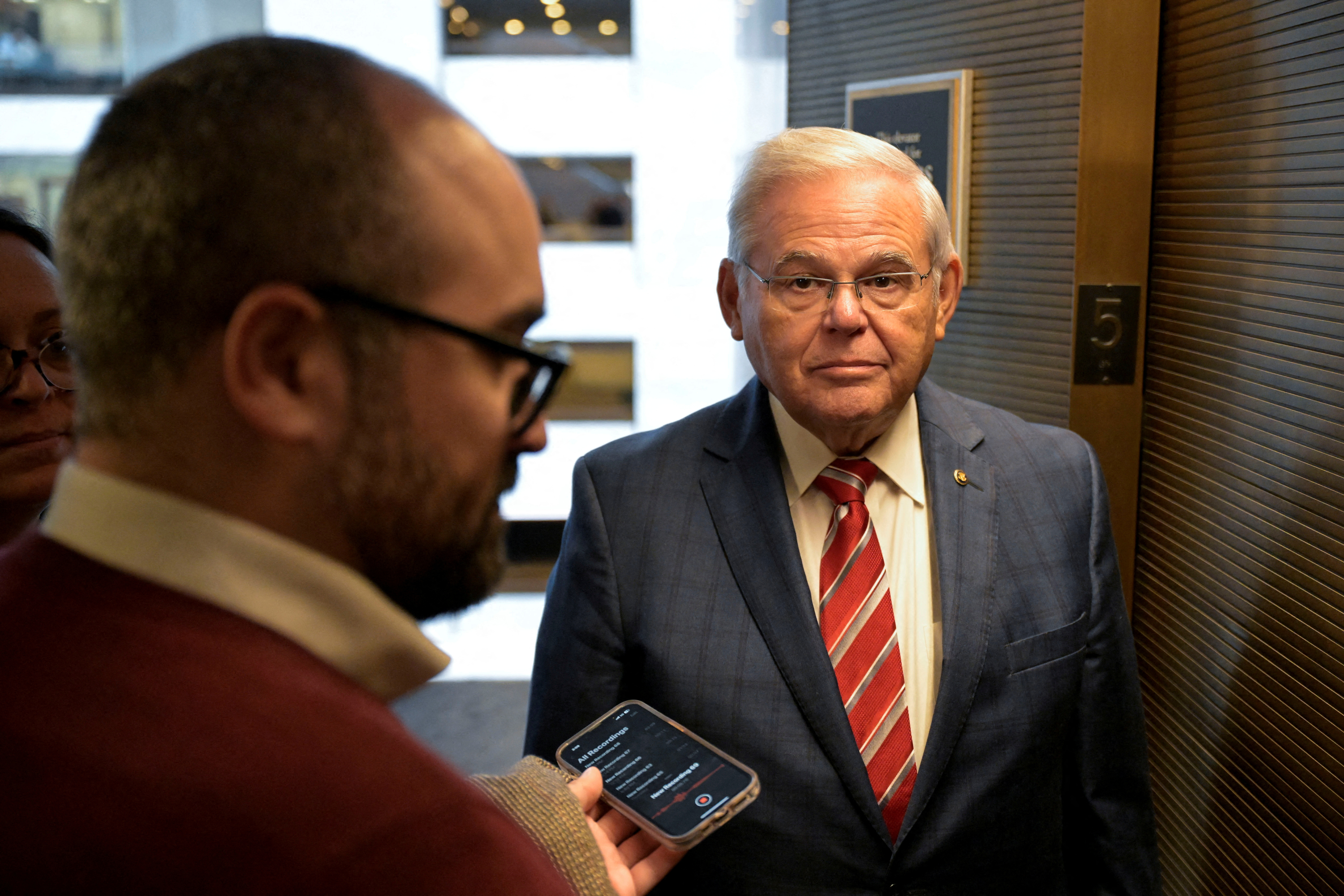 U.S. Senator Bob Menendez (D-NJ) speaks to reporters while on his way to a vote following a Senate Democratic caucus meeting on Capitol Hill in Washington, U.S., September 28, 2023. 