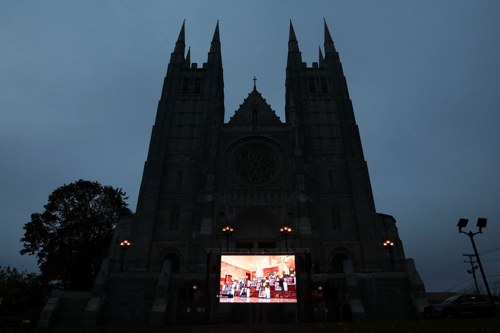 A screen is pictured as mourners take part in a vigil for the victims of the deadly mass shooting outside the Basilica of Saints Peter and Paul, in Lewiston, Maine, U.S., October 29, 2023. 