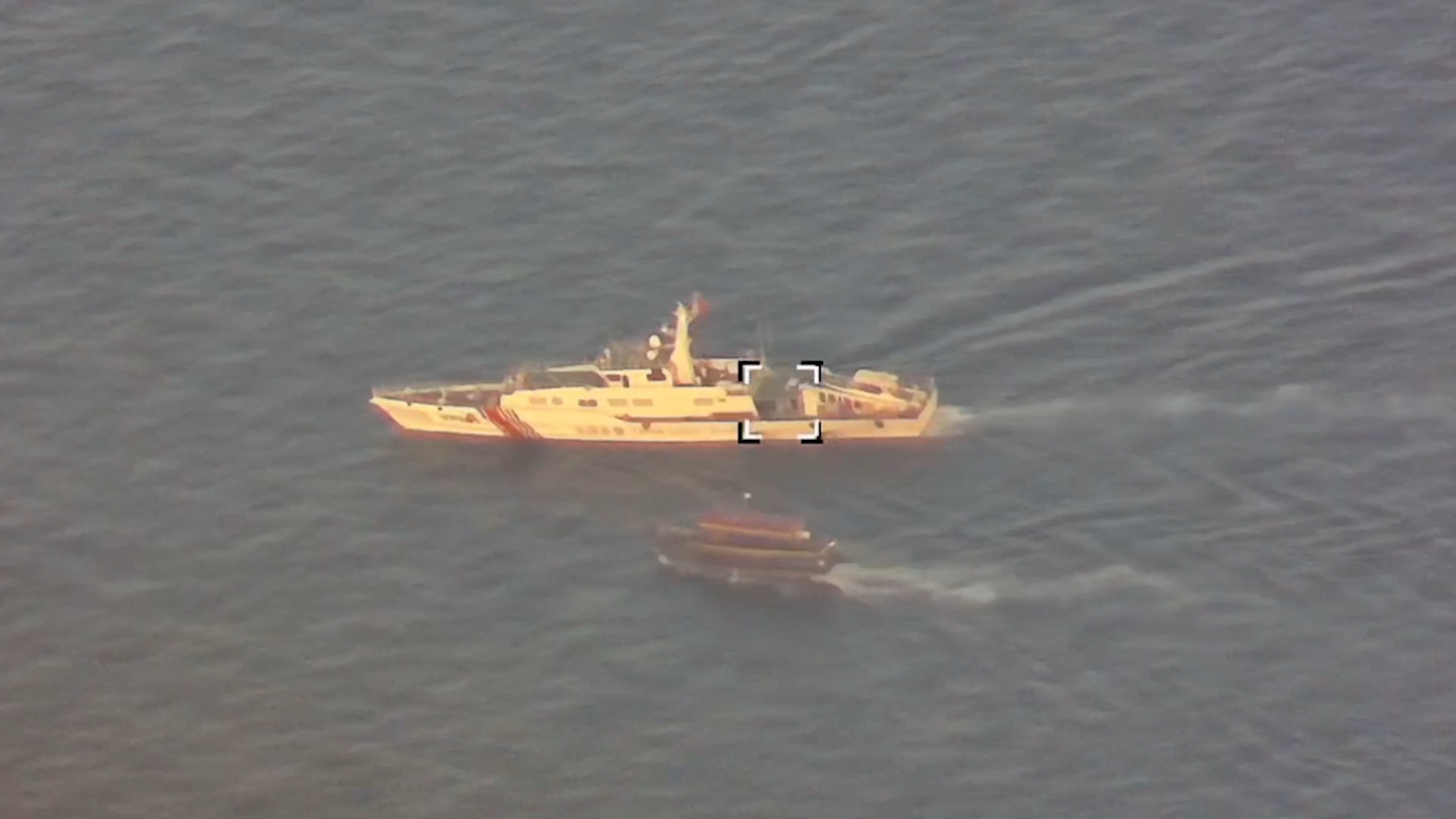 A Philippine flagged boat is blocked by a China Coast Guard vessel during an incident that resulted in a collision between the two vessels, in the disputed waters of the South China Sea in this screen grab obtained from handout video released October 22, 2023. 