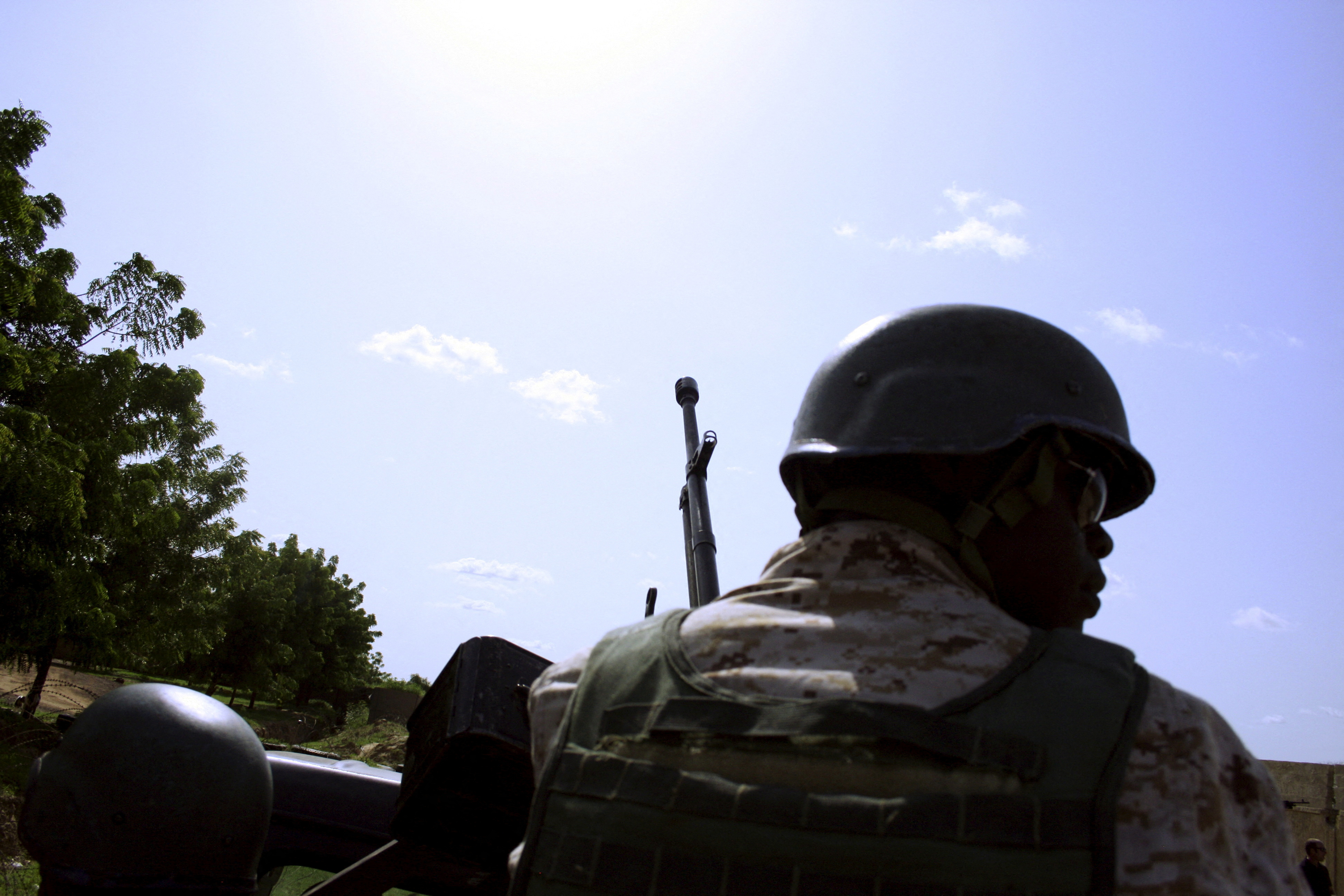 A soldier from Niger escorts U.S. soldiers back to their base following an anti-Boko Haram summit in Diffa city, Niger September 3, 2015. Picture taken September 3, 2015. 