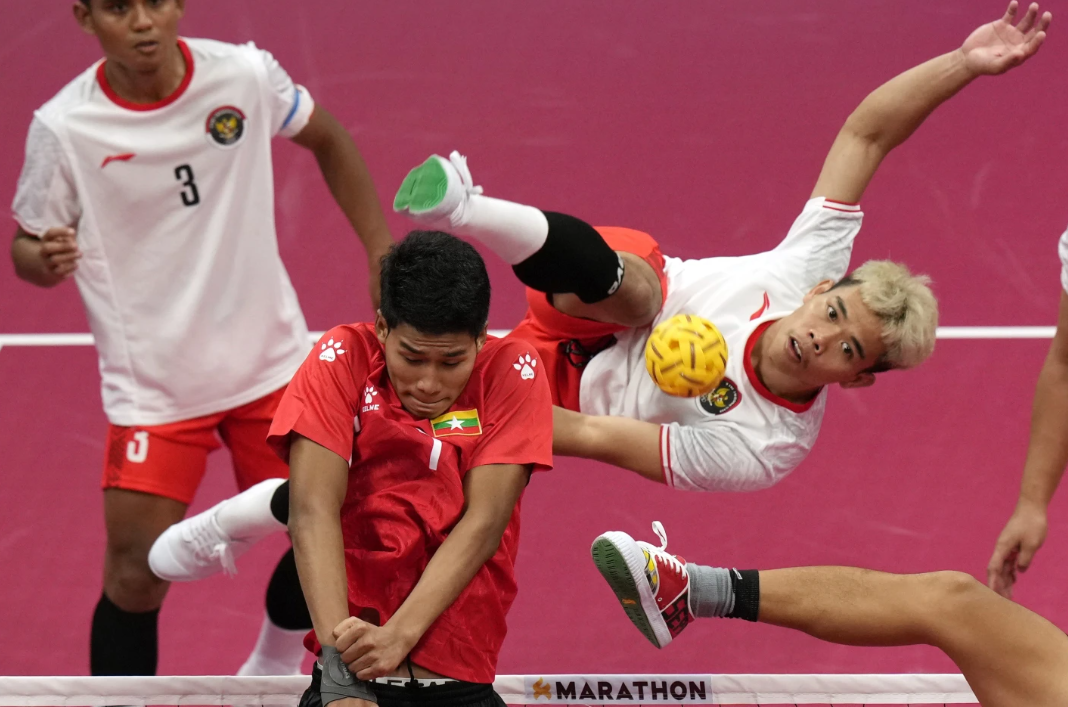 Indonesia’s Rusdi Rusdi returns the ball during the men’s Group A sepaktakraw preliminary match against Myanmar at Jinhua Sports Centre in Jinhua, China, Monday, Oct. 2, 2023.