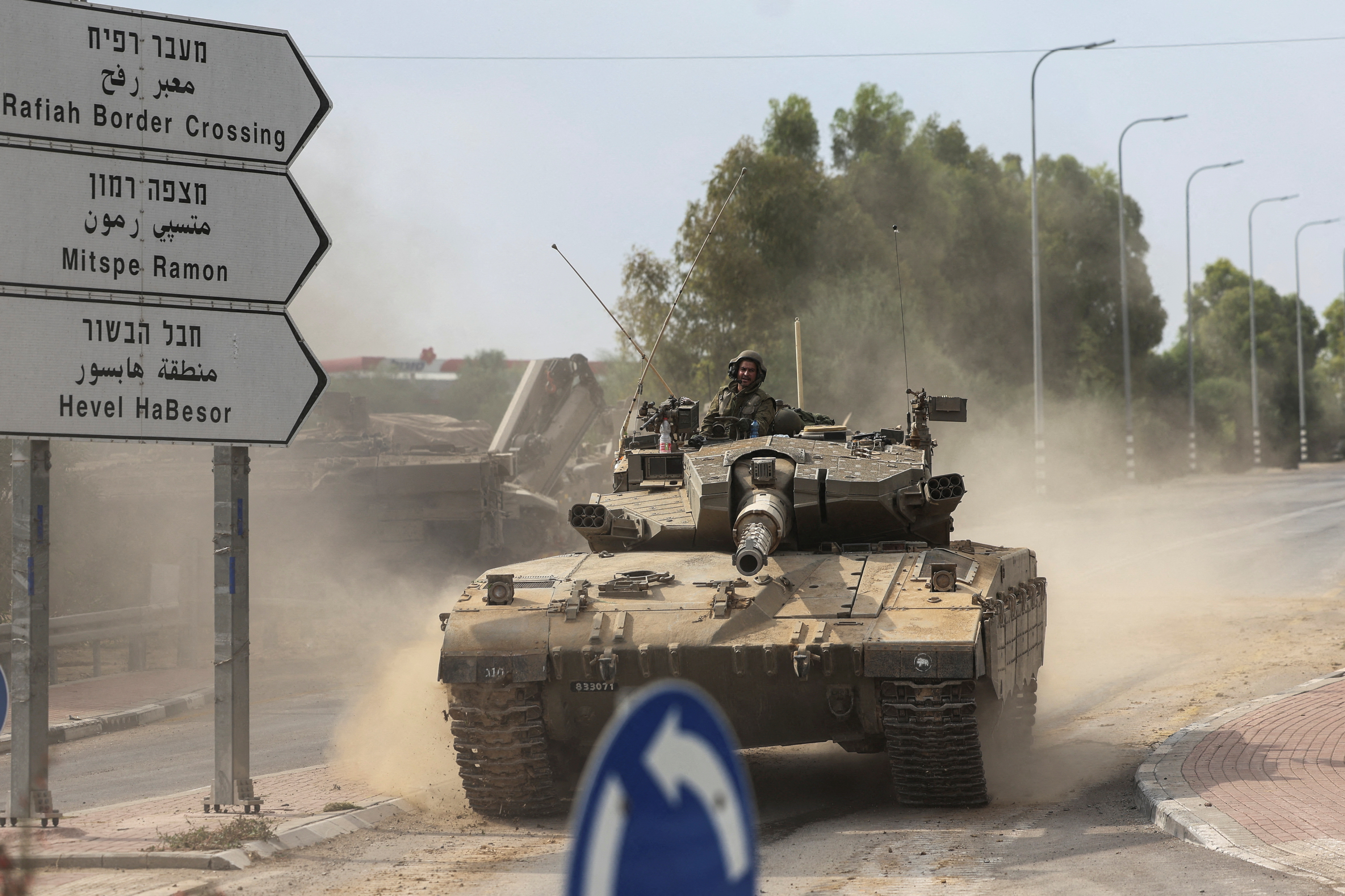 Israeli soldiers drive in a tank by Israel's border with Gaza in southern Israel, October 10, 2023. 