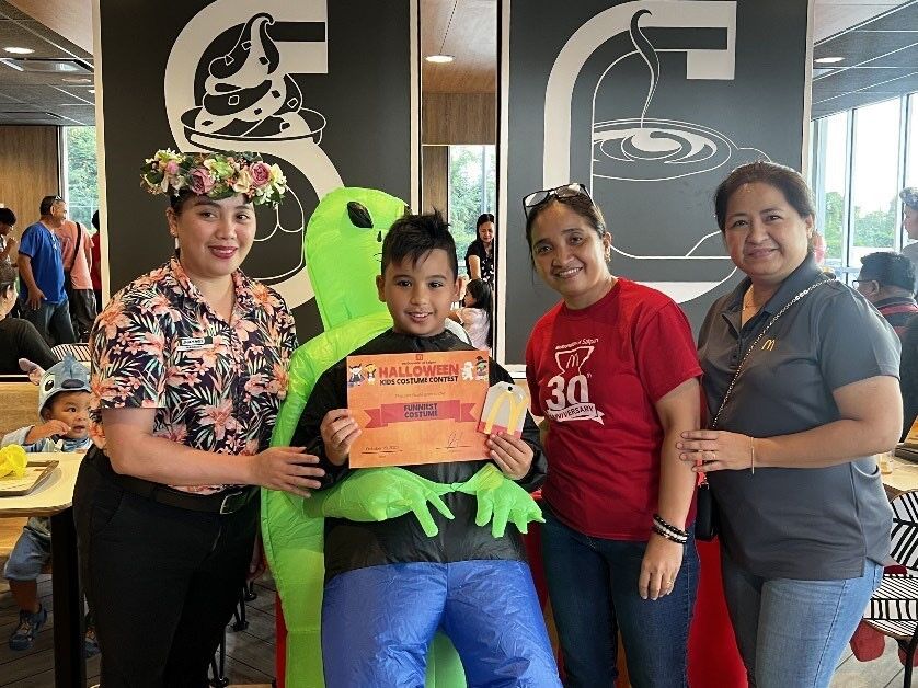 Funniest Costume winner, Geovanni Moses, poses with judges Jhaymee Nebres, McDonald’s Department Manager; Narme Menoda, McDonald’s IT/Tech Support; and Connie Medino, McDonald’s Payroll Admin.