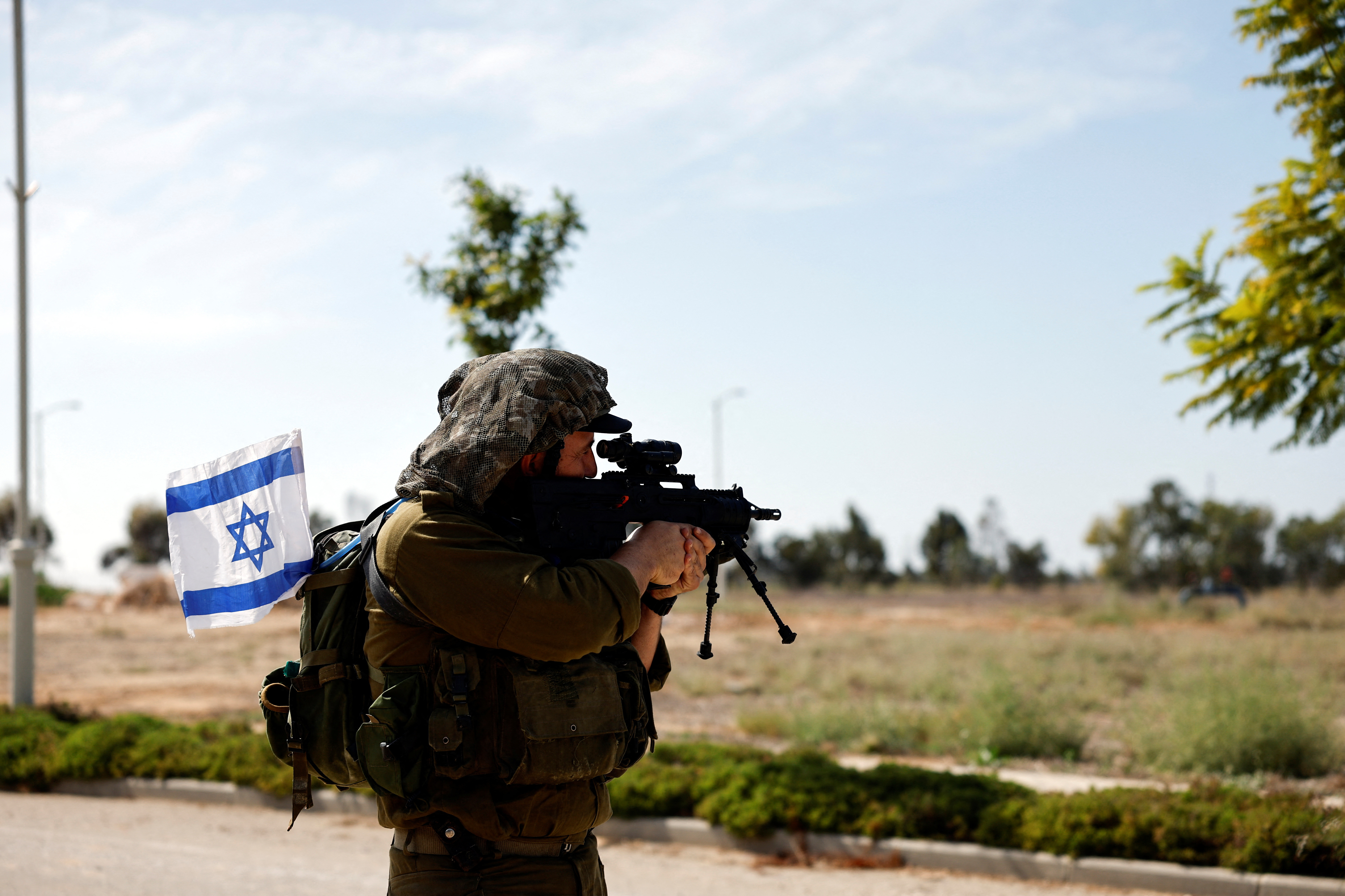 An Israeli soldier secures an area, following a deadly infiltration by Hamas gunmen from the Gaza Strip, in Kibbutz Kissufim in southern Israel October 21, 2023. 