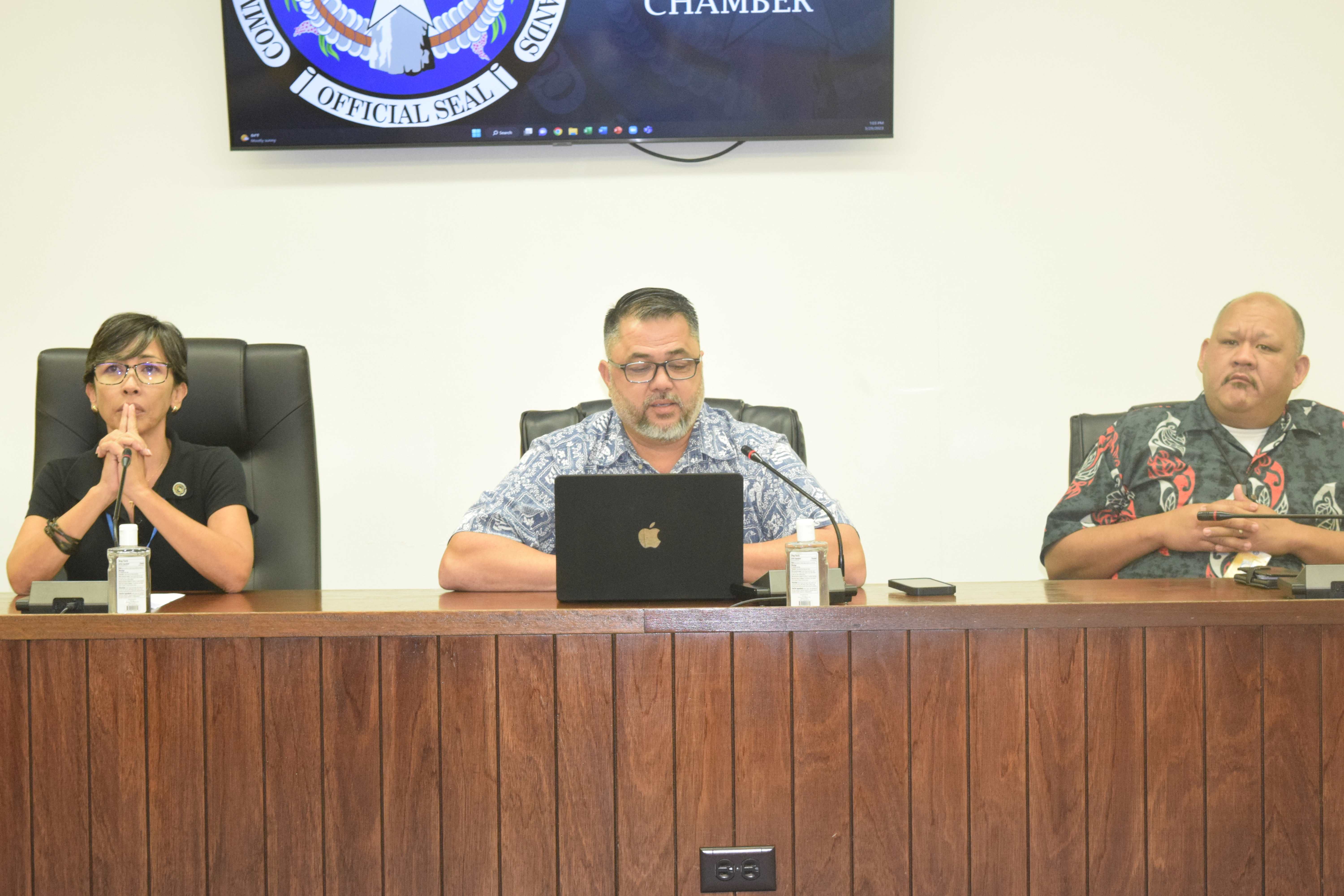 House Special Committee on Federal Assistance & Disaster-Related Funding Chairman Ralph N. Yumul, center, with Reps. Marissa Flores, left, and John Paul Sablan during a meeting in the House chamber.