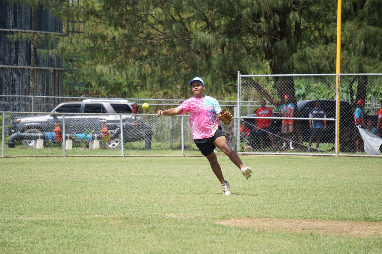 No Excuse shortstop Dennis Cabrera passes to first base for the out during a playoff game of the 2023 Belau Amateur Softball Association Open League at the Dandan baseball field on Sunday.