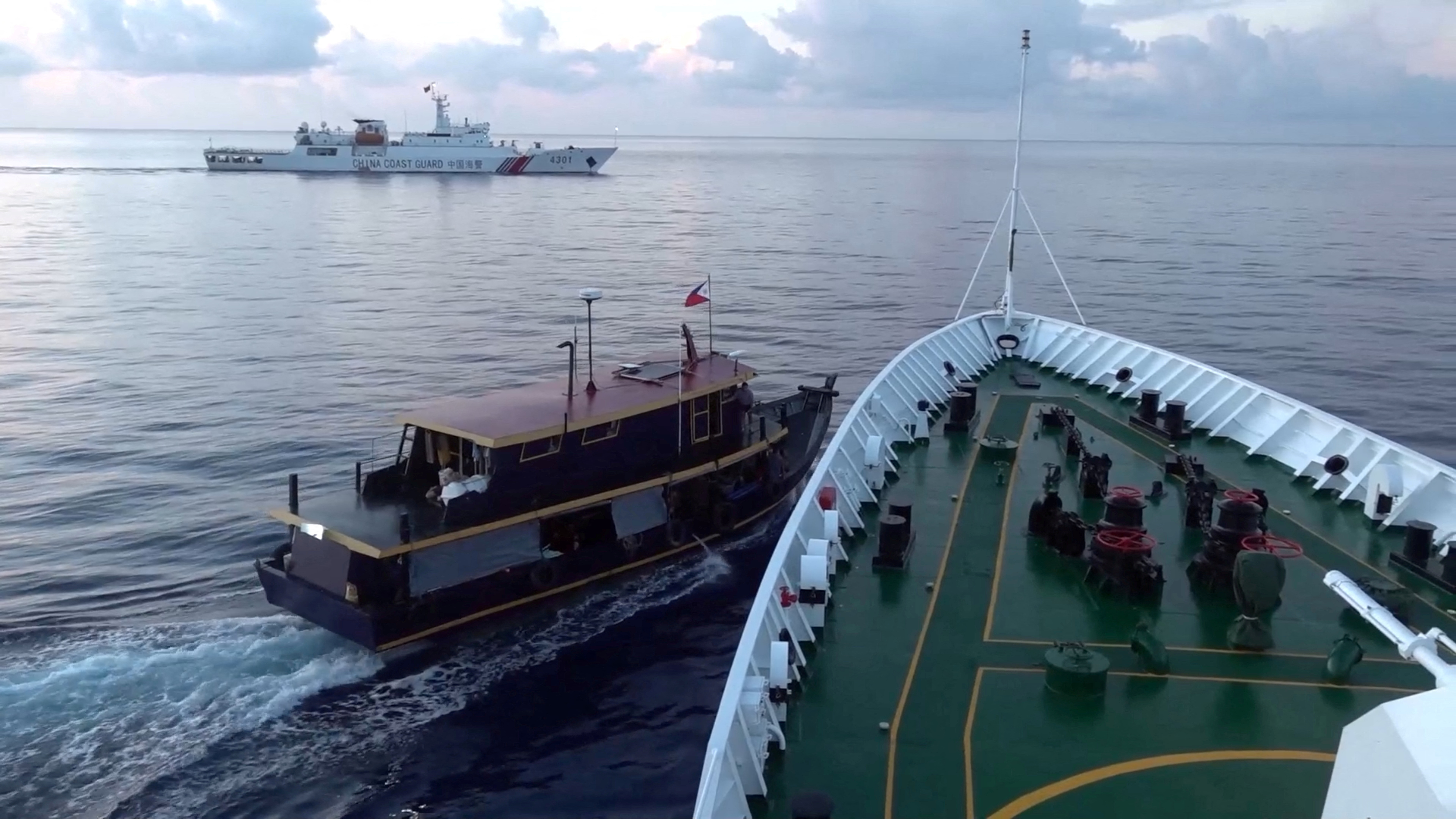 A Philippine flagged boat is blocked by a China Coast Guard vessel during an incident that resulted in a collision between the two vessels, in the disputed waters of the South China Sea in this screen grab obtained from handout video released October 22, 2023. 