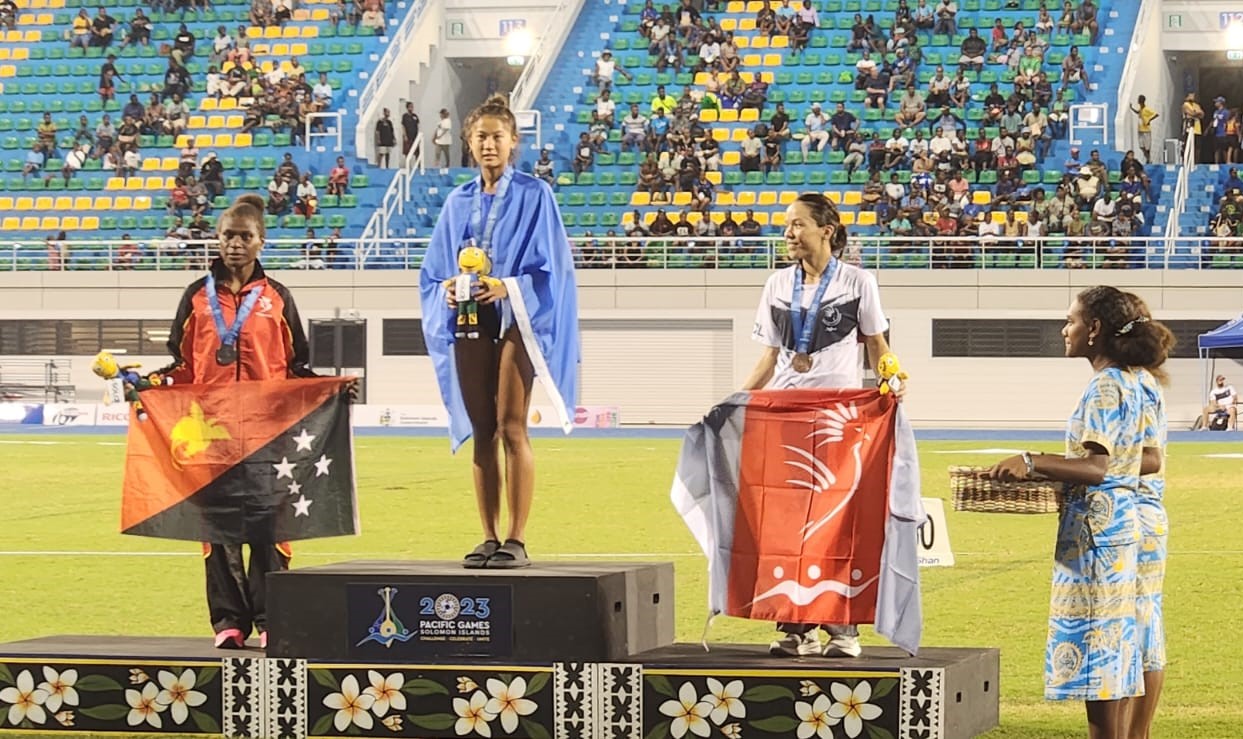 The NMI’s Tania Tan, center, won the gold medal in the 5,000m run of the 2023 Pacific Games on Monday.