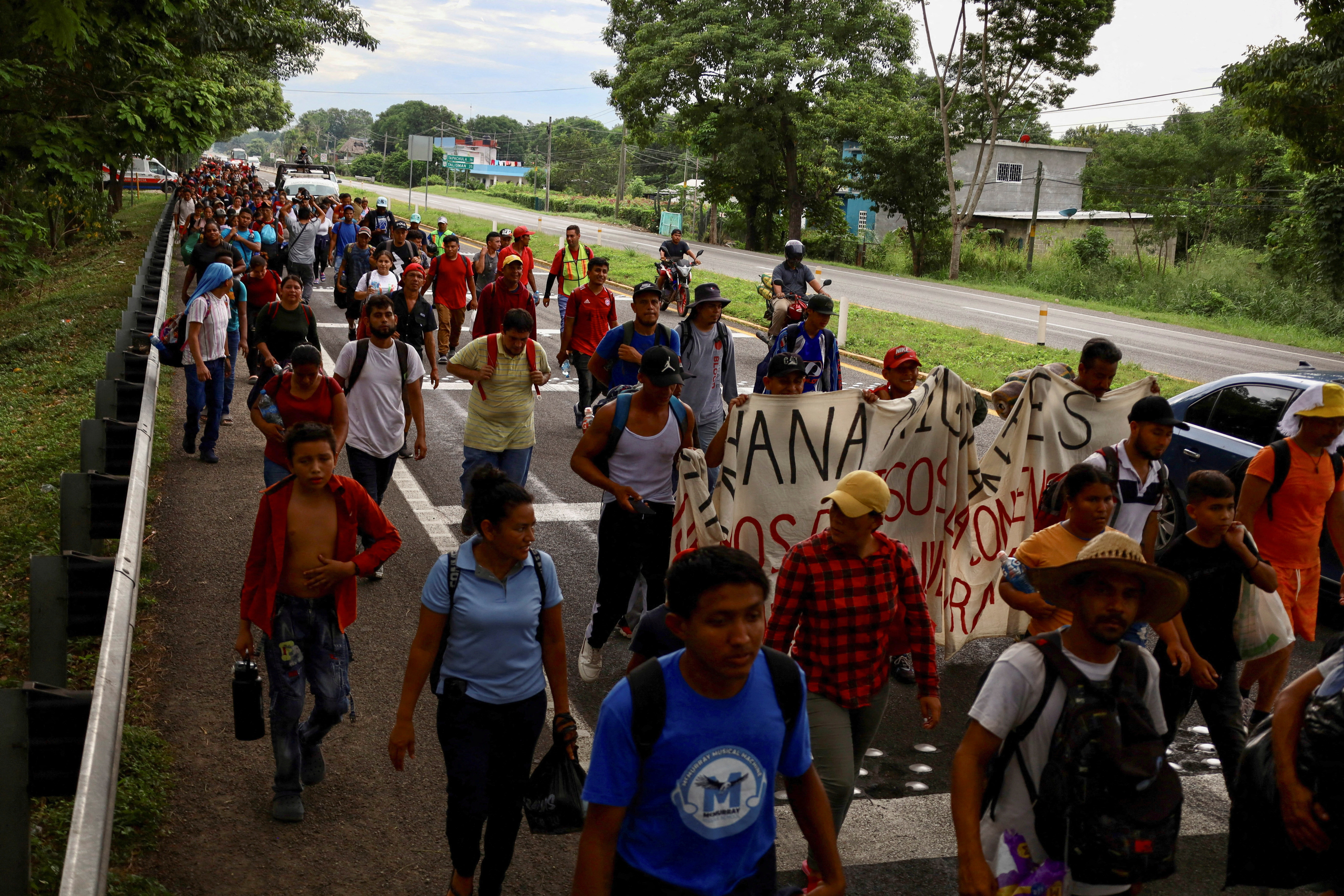 Migrants walk along the road in a caravan in an attempt to reach the U.S border, in Tapachula, Mexico November 5, 2023. 