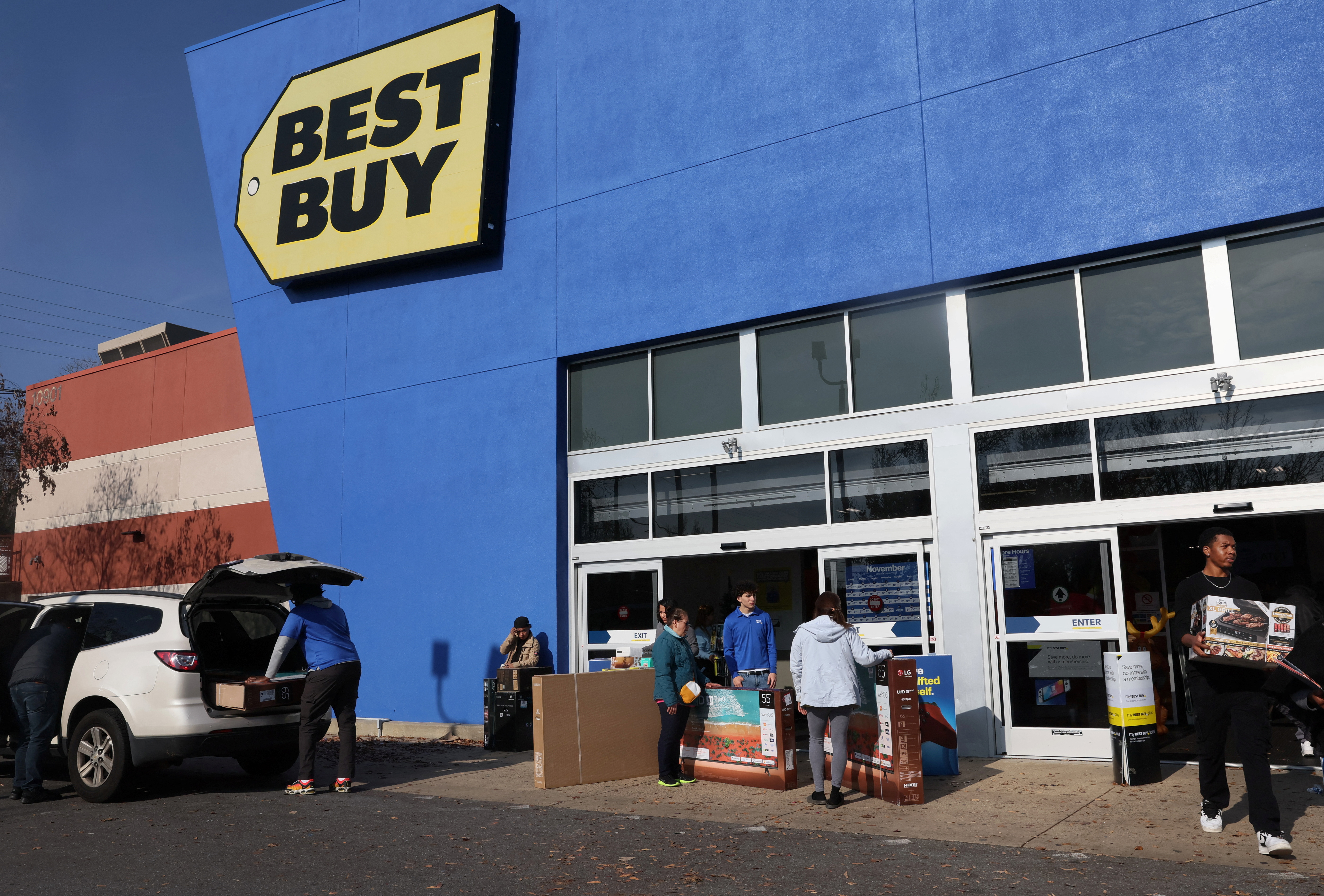 People load up their newly purchased items from Best Buy on Black Friday in Wheaton-Glenmont, Maryland, U.S., November 24, 2023. 