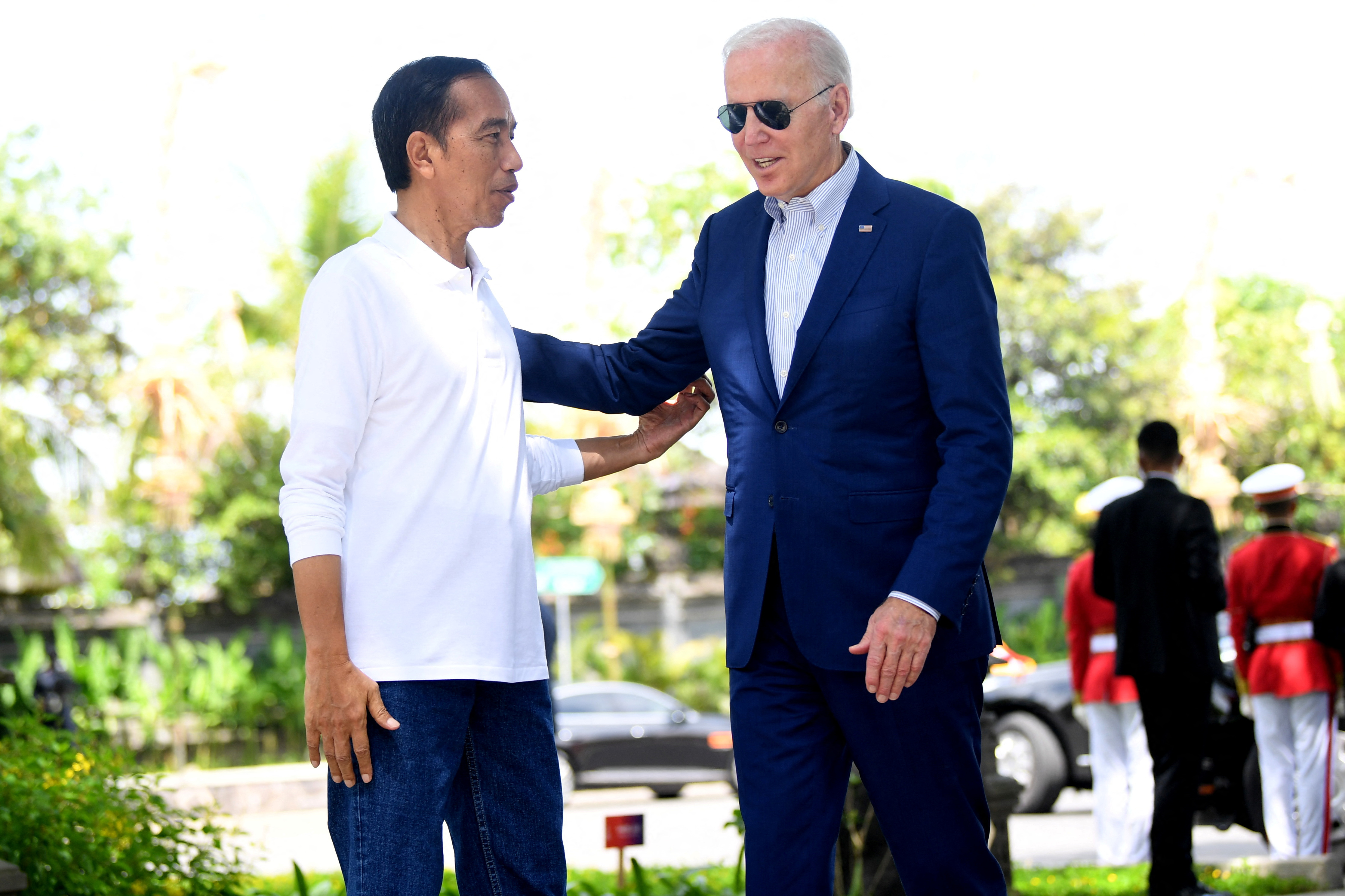 Indonesian President Joko Widodo welcomes the arrival of the United States President Joe Biden while visiting the mangroves nurseries and plantation site on the second day of the G20 Indonesia Summit events at the Ngurah Rai Forest Park, Denpasar, Bali, Indonesia, Nov. 16, 2022. 