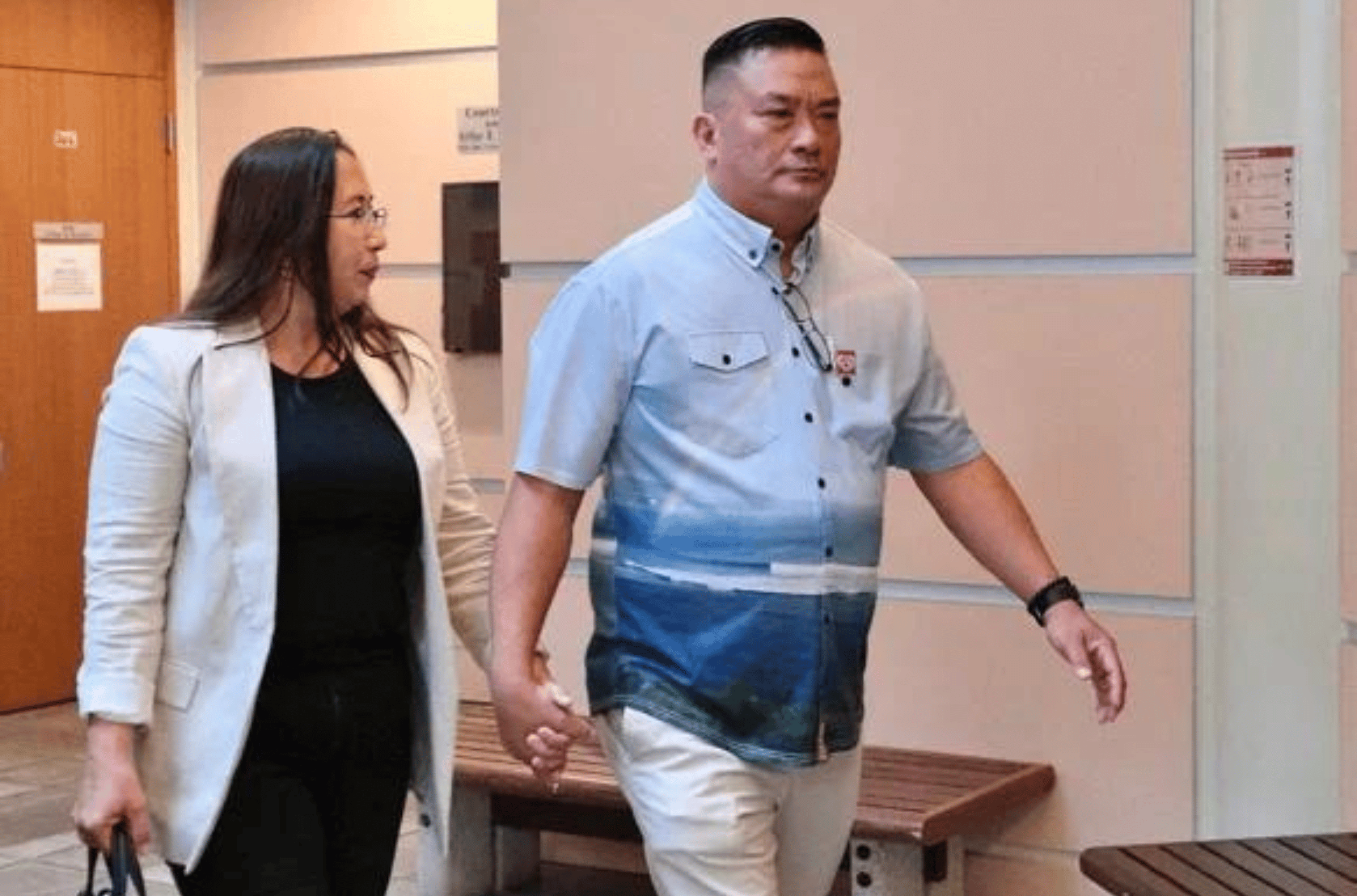 Richard Ybanez, the former interim executive manager of the Guam Regional Transit Authority, right, walks to a pretrial conference Tuesday, Aug. 22, 2023, at the Guam Judicial Center in Hagåtña.   