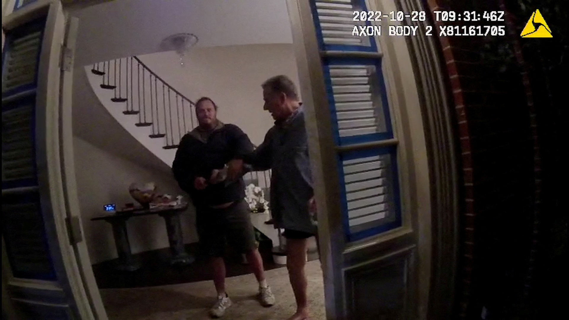A screenshot from a police body camera video shows David DePape holding onto Paul Pelosi, the husband of then-House Speaker Nancy Pelosi, in the couple’s house on October 28, 2022.
