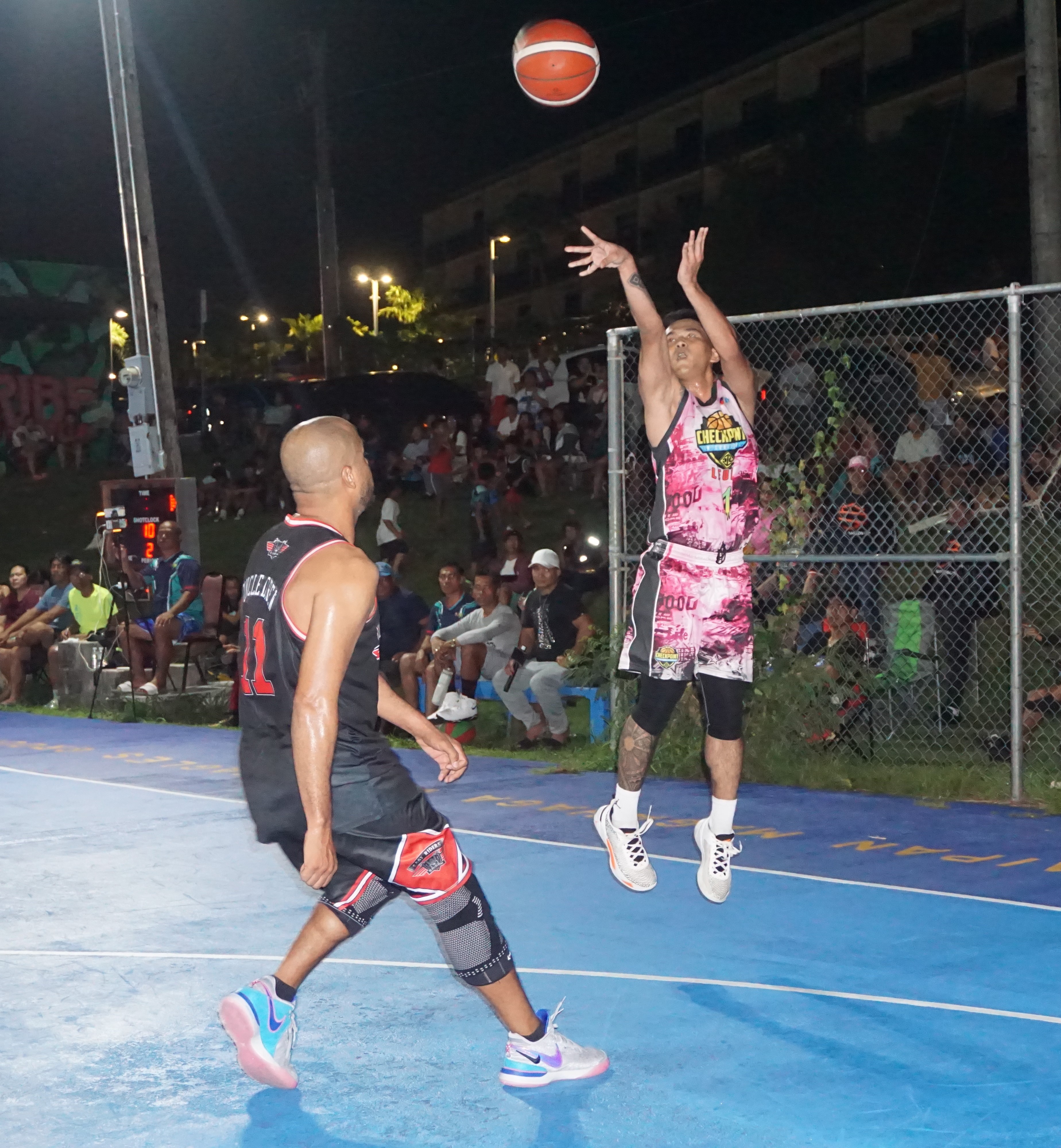 Checkpoint's Keith Santos pulls up for the three-pointer over Easy Riders' Andrew Ashburn during the open division championship game of the 2023 Saipan Magalahi Eagles Club Invitational Basketball League on Saturday at the Gualo Rai basketball court.