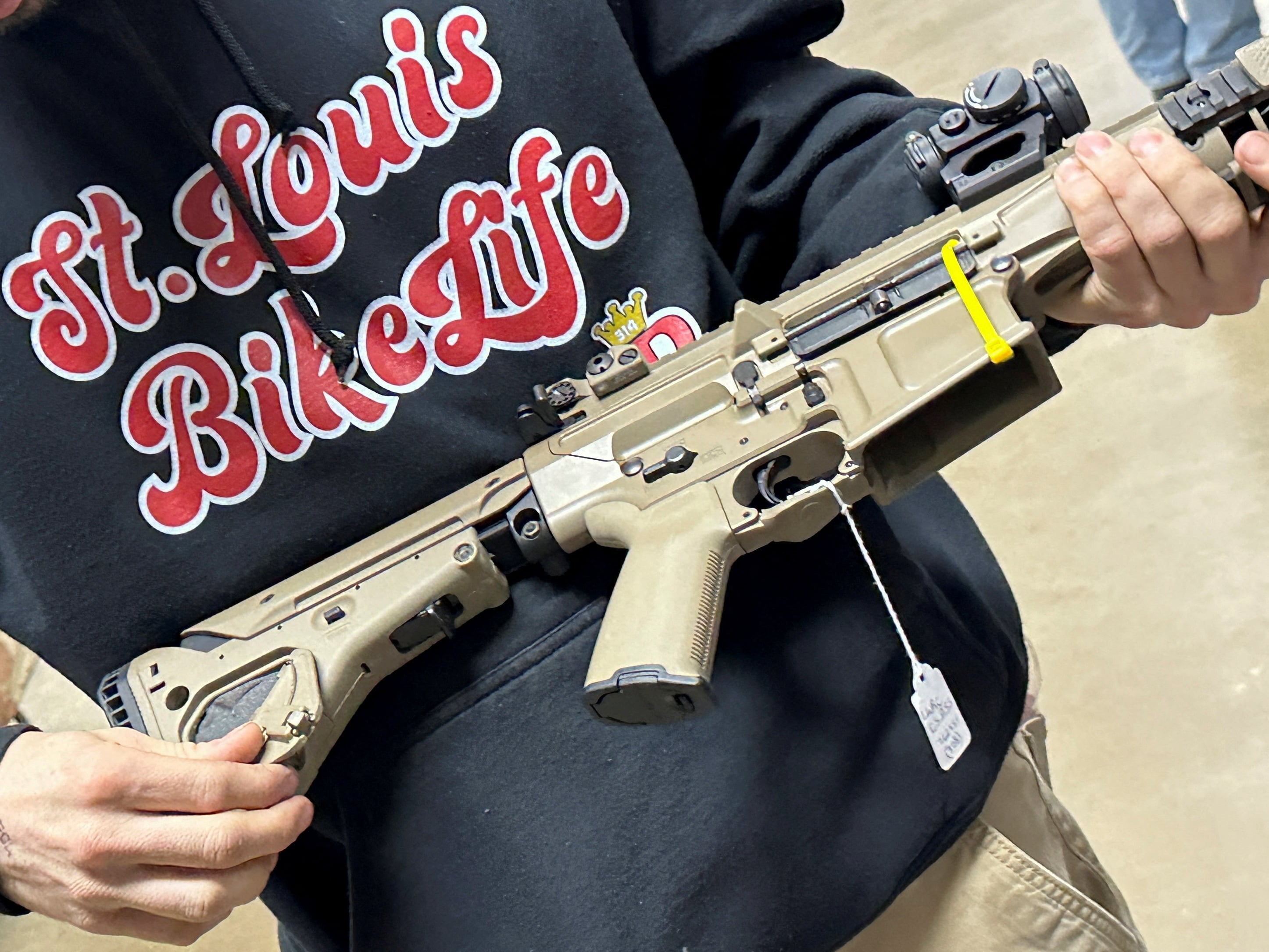 A man examines an AR-10 for sale at the Belle-Clair Fairgrounds & Expo Center Gun Show, after the state of Illinois passed its "assault weapons" ban into law, in Belleville, Illinois, U.S., January 14, 2023. 