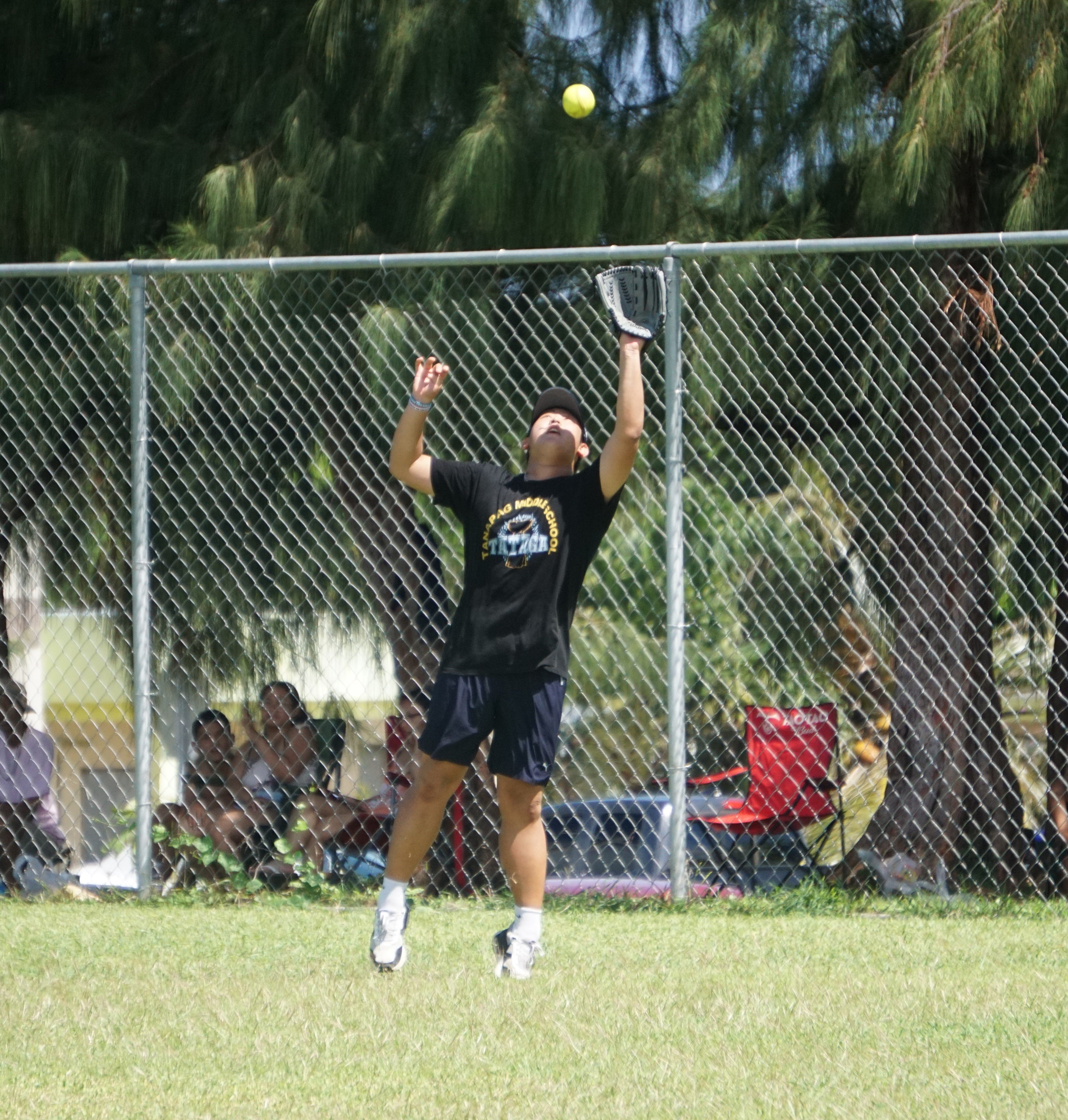 MCS V right centerfielder Minsoo Kwon extends to catch a fly ball during a game of the SBL-PSS Interscholastic Boys High School Slow Pitch Softball League SY 23-24 on Saturday at the Dandan baseball field.