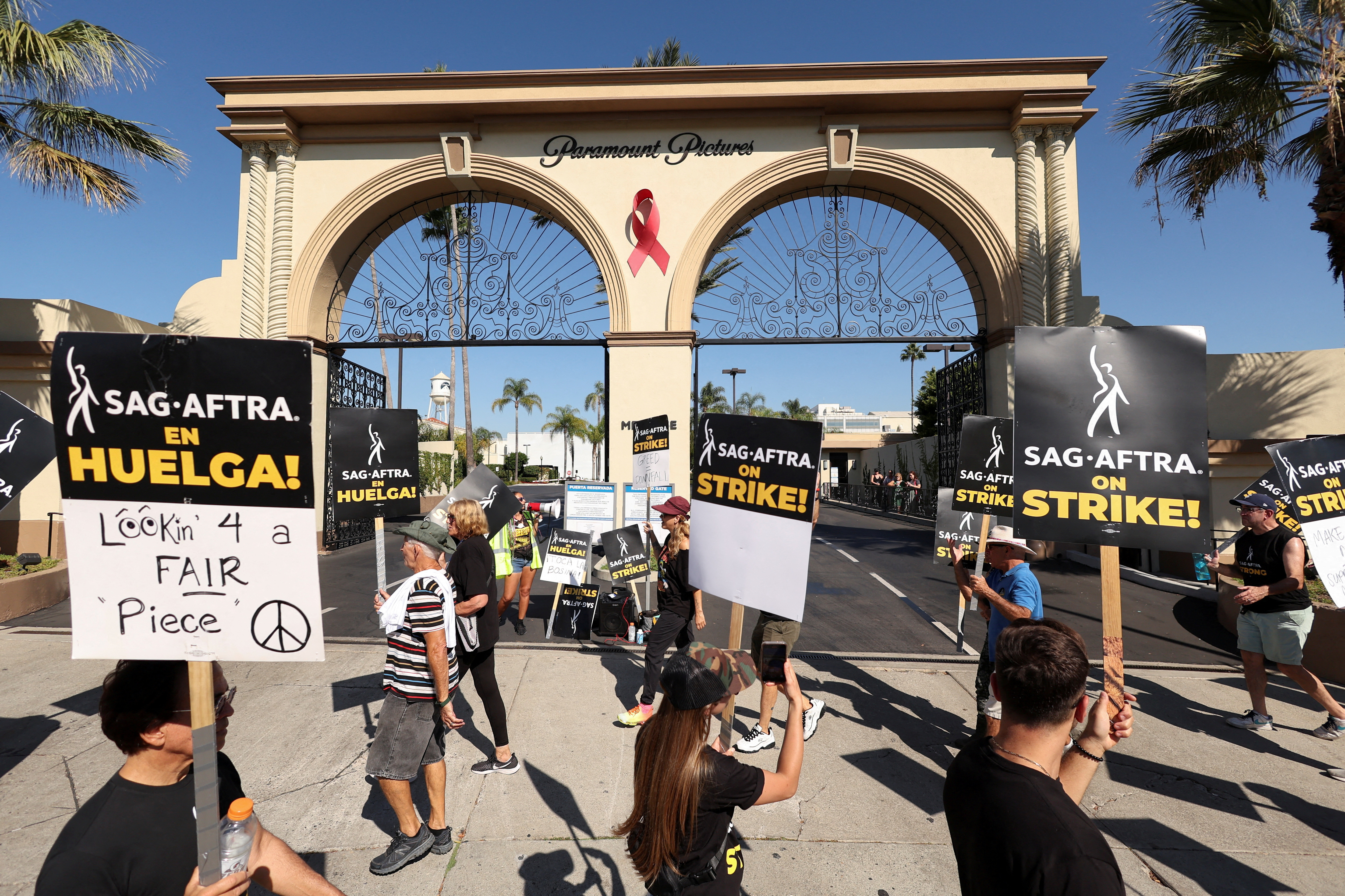 SAG-AFTRA members walk the picket line on the 100th day of their ongoing strike outside Paramount Studios in Los Angeles, California, U.S., October 20, 2023. 