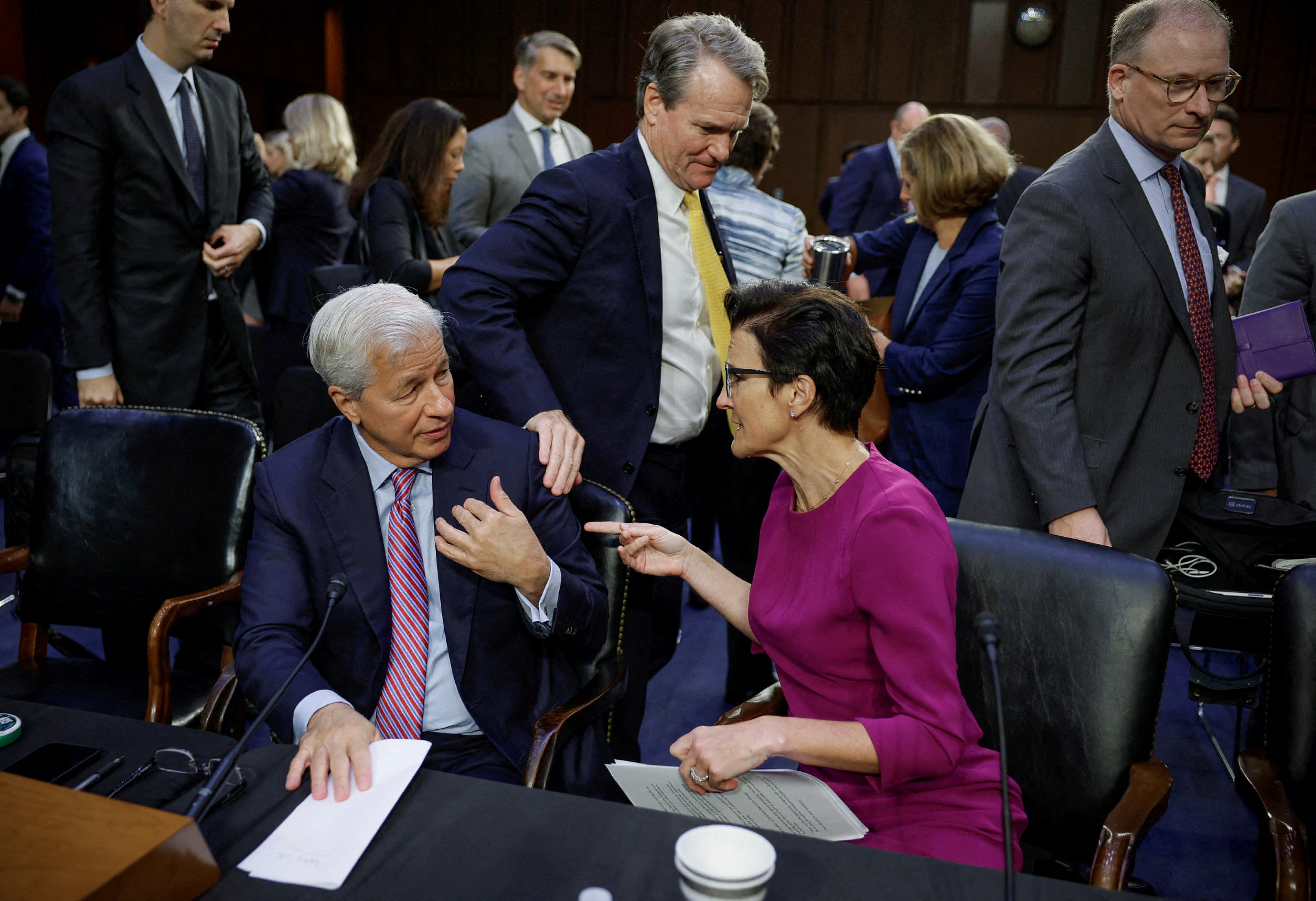 JPMorgan Chase and Company Chairman and CEO Jamie Dimon, Citigroup CEO Jane Fraser, and Bank of America Chairman and CEO Brian Moynihan, talk following their testimony before a Senate Banking, Housing, and Urban Affairs hearing on "Annual Oversight of the Nation's Largest Banks", on Capitol Hill in Washington, U.S., September 22, 2022. 