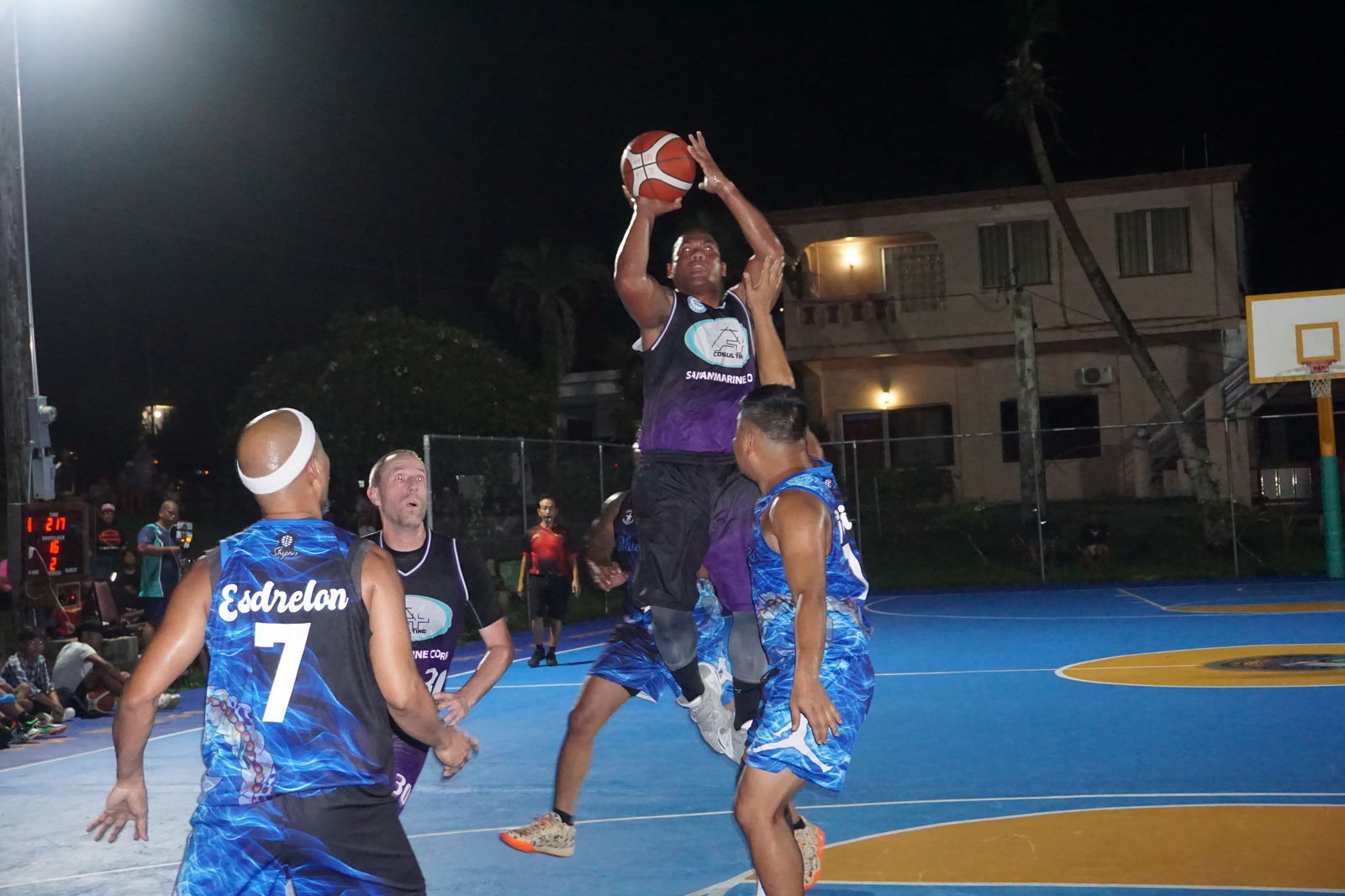 A Plus Team's Gino Libuw takes the perimeter shot over two defenders.