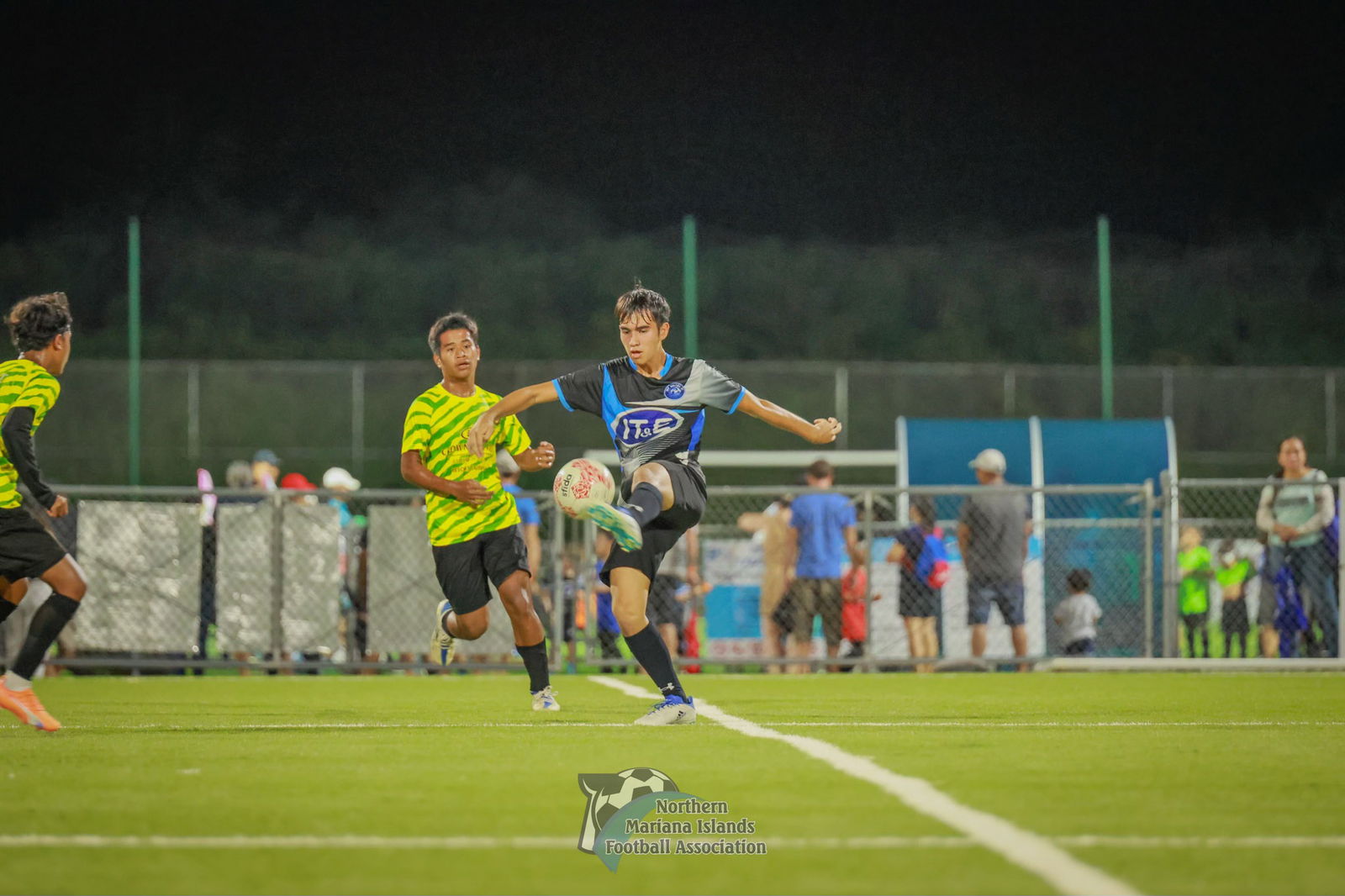 An MPU player reaches out to control the possession during  a U17 boys division game of the TakeCare Youth Soccer League Fall 2023 at the NMI Soccer Training Center in Koblerville. 