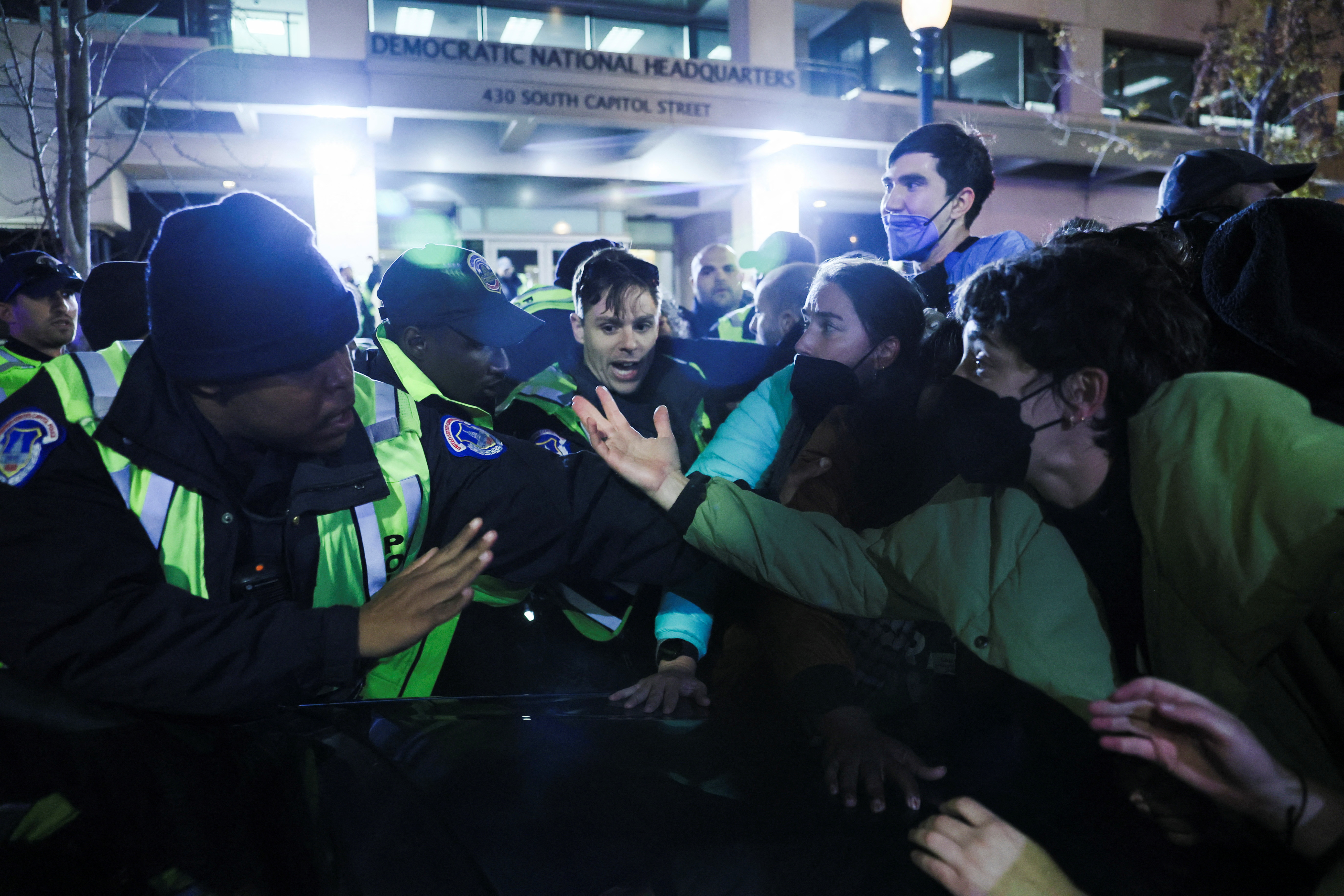 Police and demonstrators argue at the entrance to the Democratic National Headquarters during a multi-denominational event hosted by the Democratic Socialists of America, IfNotNow Movement and Jewish Voice for Peace calling for a ceasefire in the conflict between Israel and Palestinian Islamist group Hamas, in Washington, U.S. November 15, 2023. 