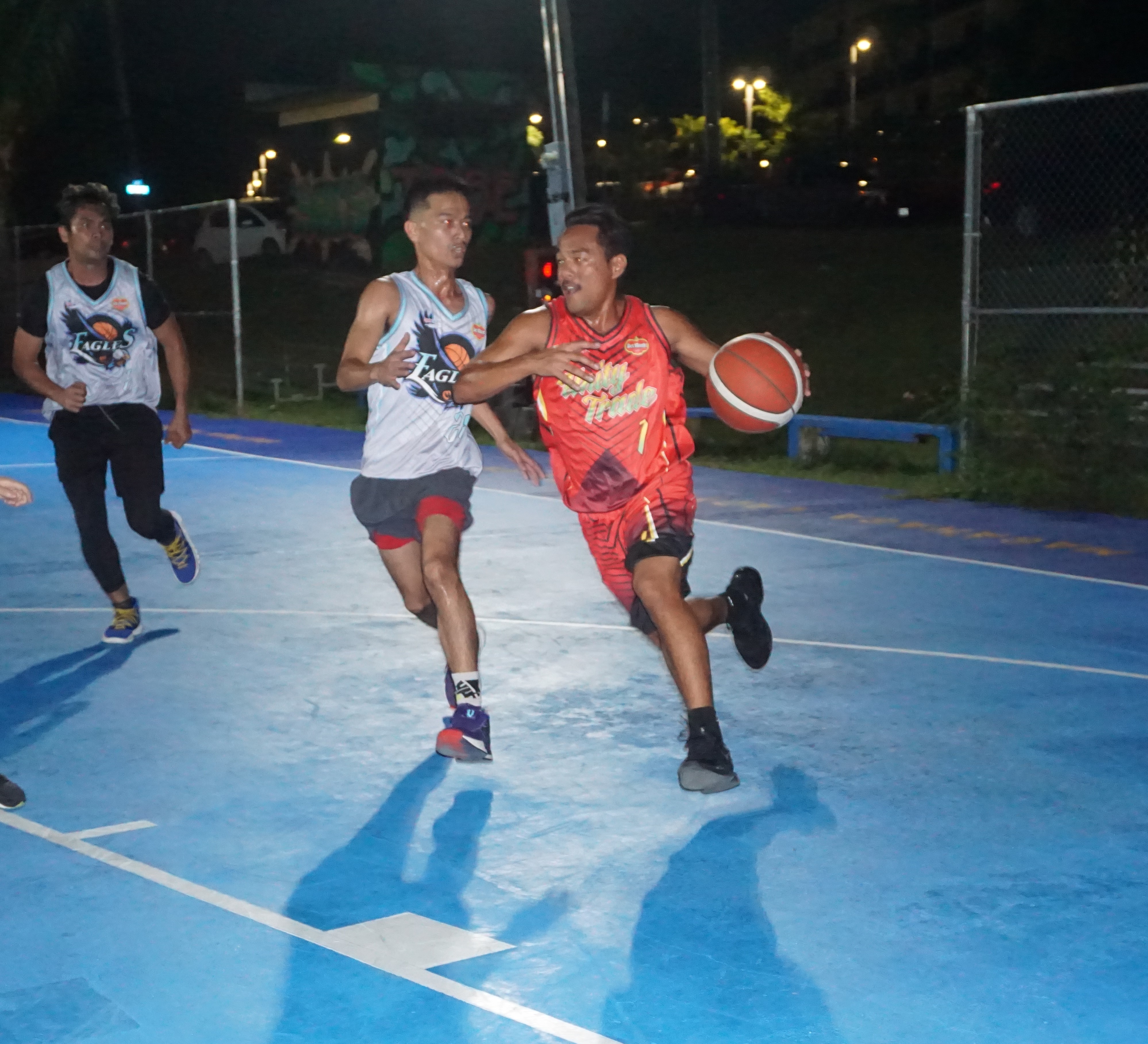 Unity Trade's Dhan Mateo protects the ball as he attempts to drive towards the basket during a game of the 2023 Pacific Saipan Promo Invitational Basketball League Thursday at the Gualo Rai basketball court.
