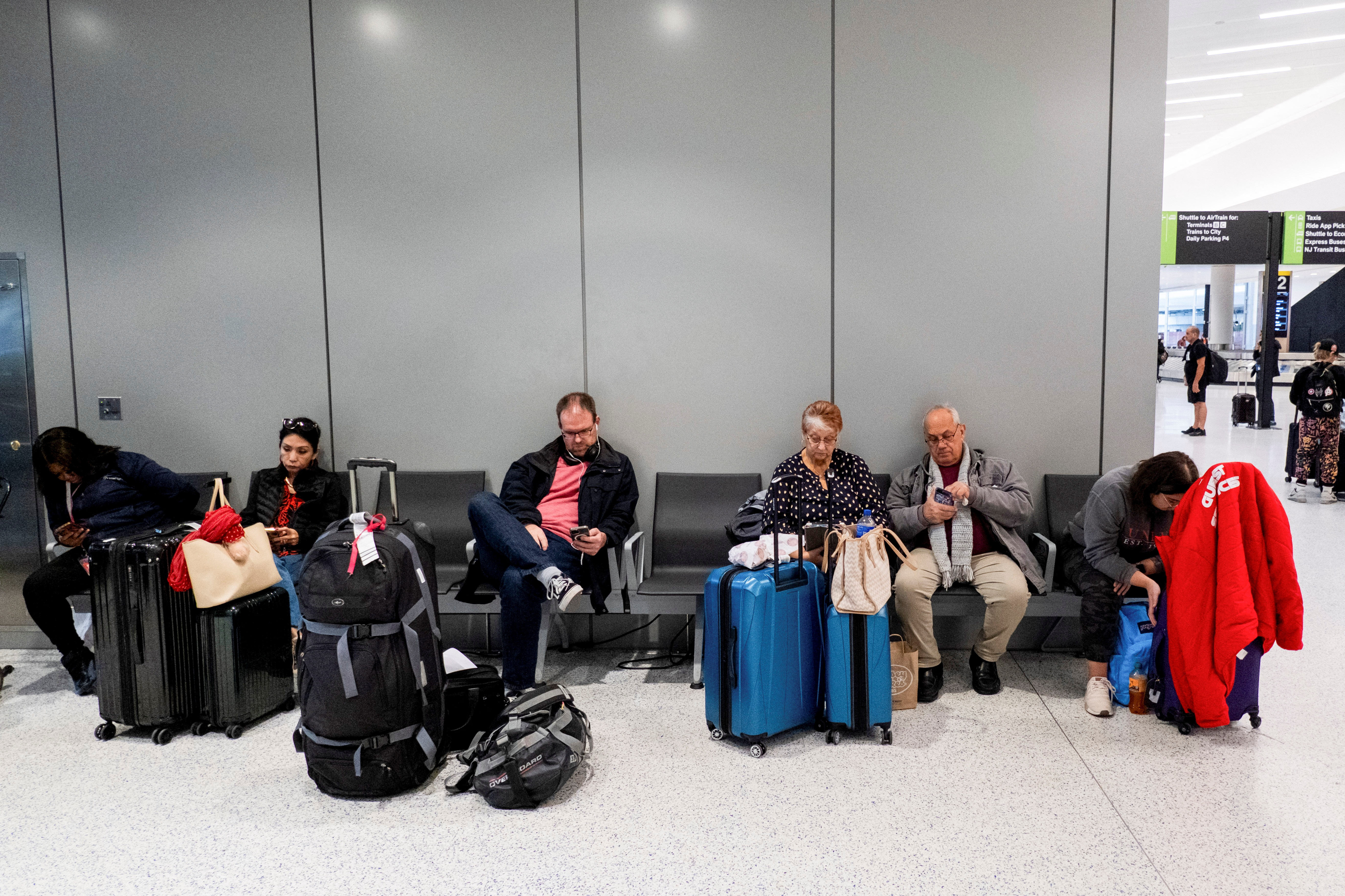 People wait at Newark Liberty International Airport, ahead of the Thanksgiving holiday, in Newark, New Jersey, U.S. November 22, 2023. 