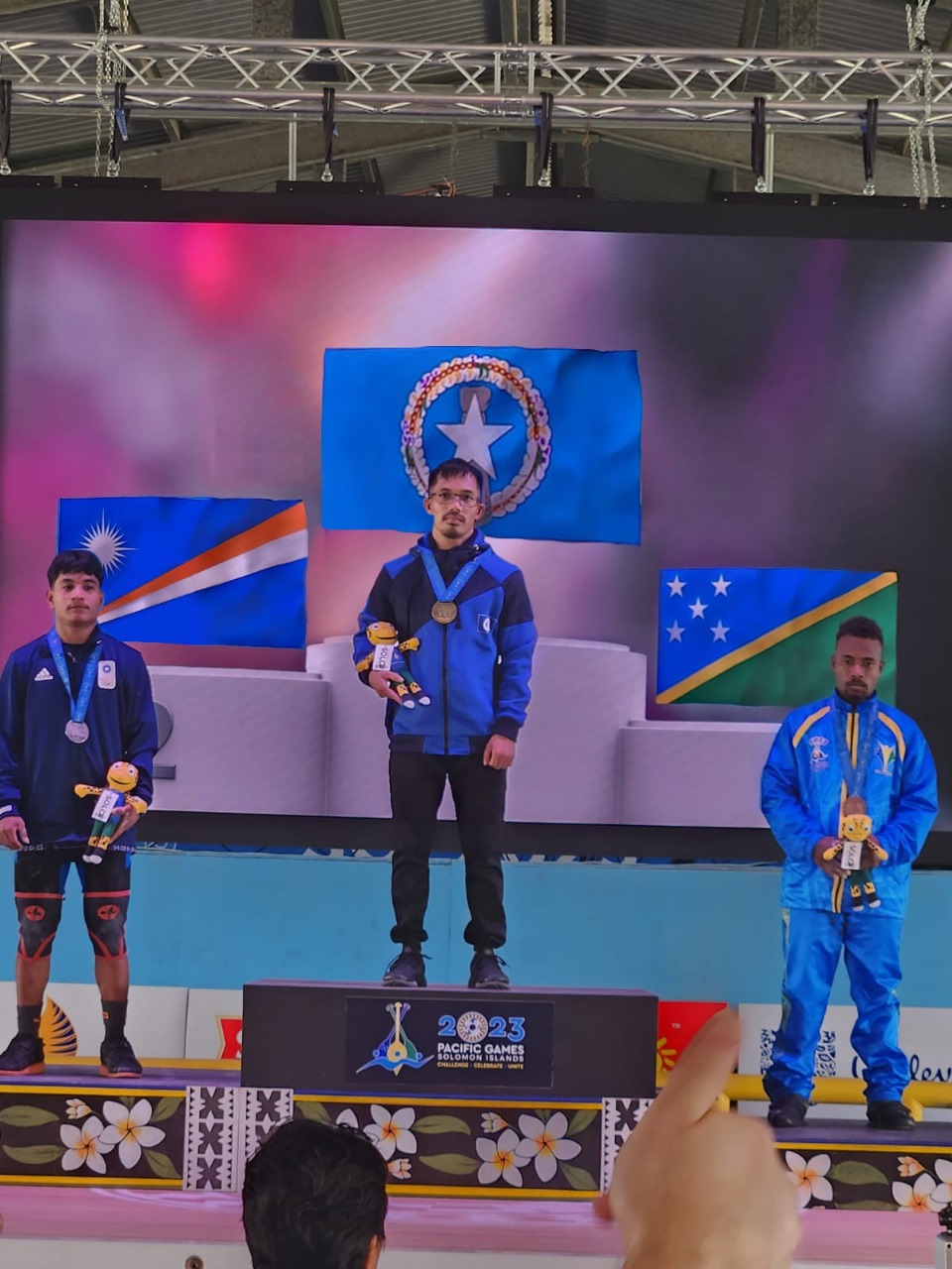 The NMI's Raymond Santos, center, poses with Marshall Islands' Mike Riklon, left, and Solomon Islands' Philip Masi during the medal ceremony for the men's 55kg class (snatch) of the weightlifting competition in the 2023 Pacific Games Monday at the Maranatha Hall in Honiara, the Solomon Islands.