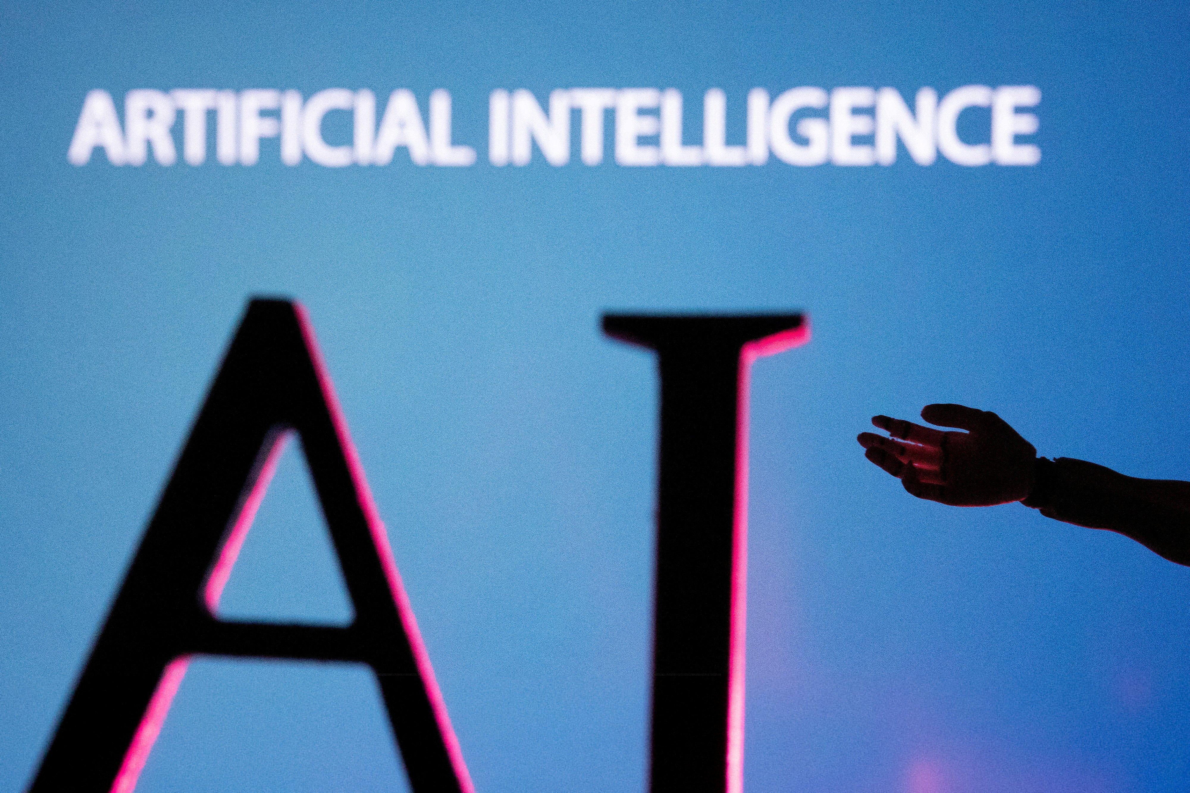 FILE PHOTO: AI (Artificial Intelligence) letters and robot hand miniature in this illustration taken, June 23, 2023. 
