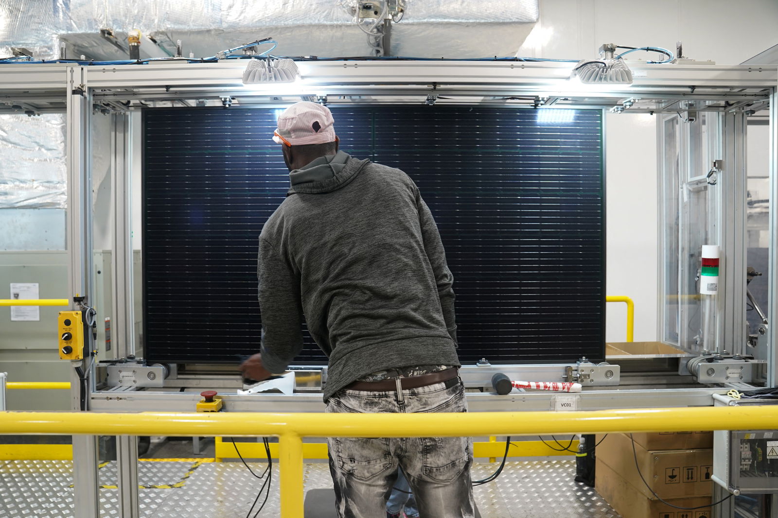An employee works on solar panels at the QCells solar energy manufacturing factory in Dalton, Georgia, March 2, 2023.