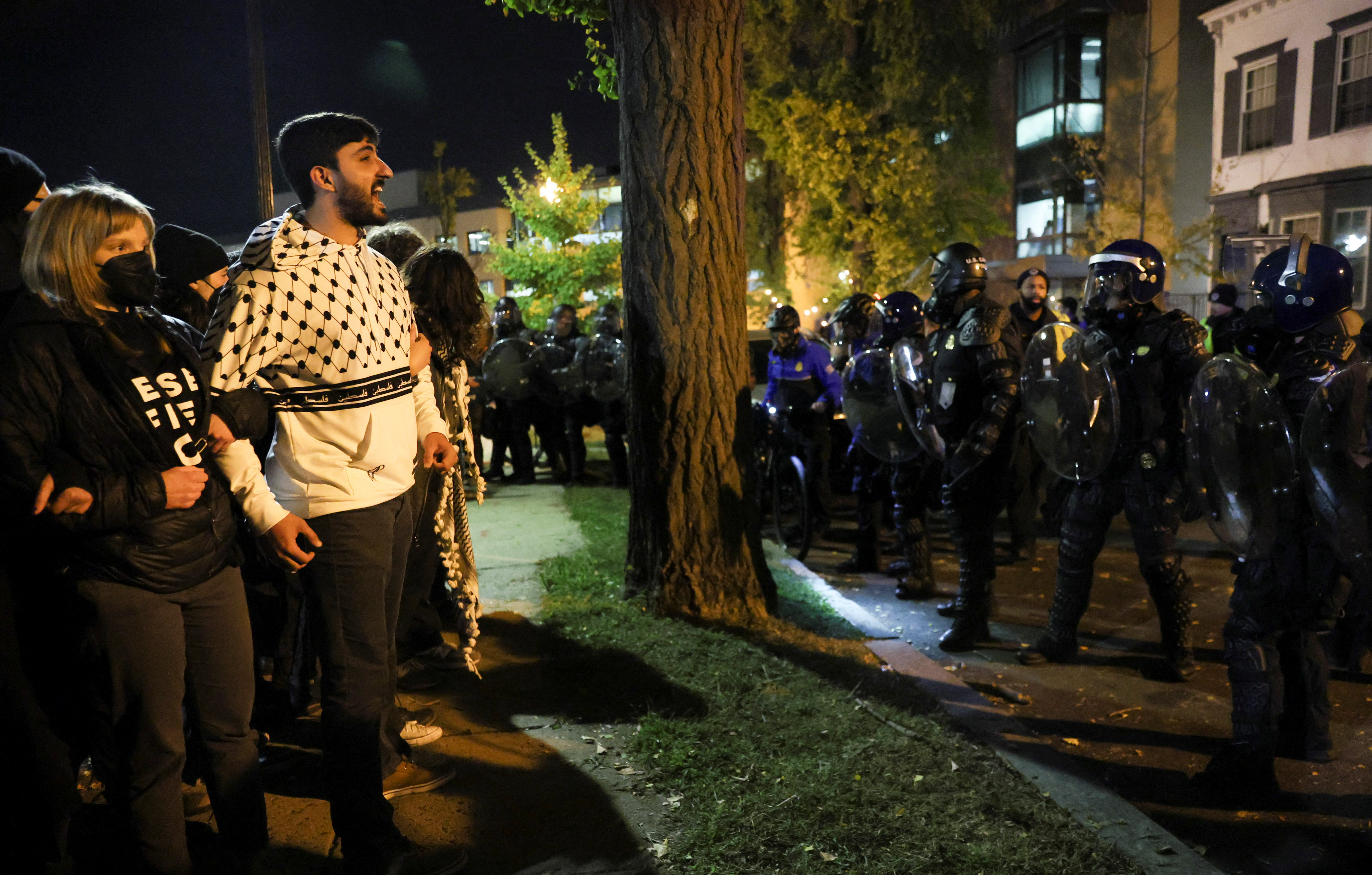 Demonstrators stand facing police officers as people march during a multi-denominational event hosted by the Democratic Socialists of America, IfNotNow Movement and Jewish Voice for Peace calling for a ceasefire in the conflict between Israel and Palestinian Islamist group Hamas, in Washington, U.S. November 15, 2023. 