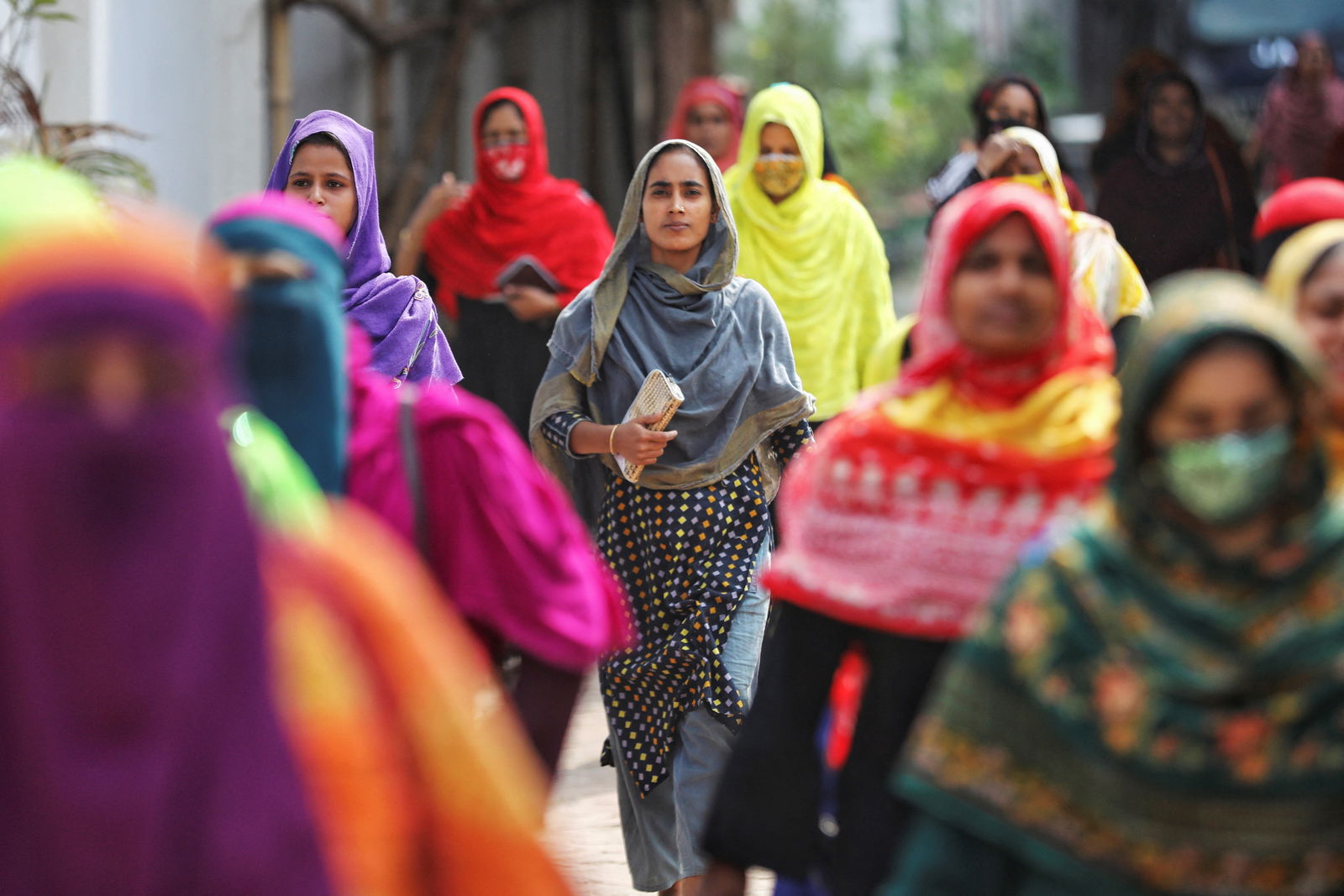 Garment workers come out of a factory during lunch hours at the Ashulia area, outskirts of Dhaka, Bangladesh, Nov. 8, 2023.